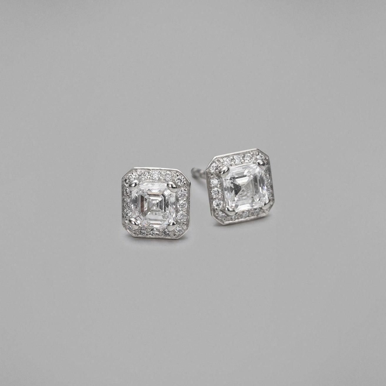 BUNDA 'Sitara' Diamond Stud Earrings with Asscher Cut Diamonds surrounded in a halo of Round Brilliant Cut Diamonds. Made in Platinum, Signed BUNDA.

Characteristics of Asscher Cut Diamond; 0.51ct, D colour / VS2 Clarity. GIA