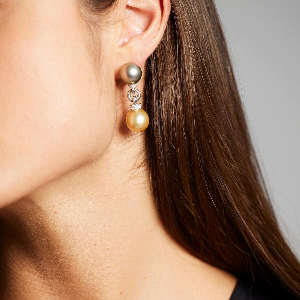 A pair of BUNDA Cultured Tahitian and Australian South Sea pearl earrings, with round and oval-shaped pearls of clean skin and excellent lustre; gold, white and peacock green in colour. Set in platinum and diamonds with a post/ clip