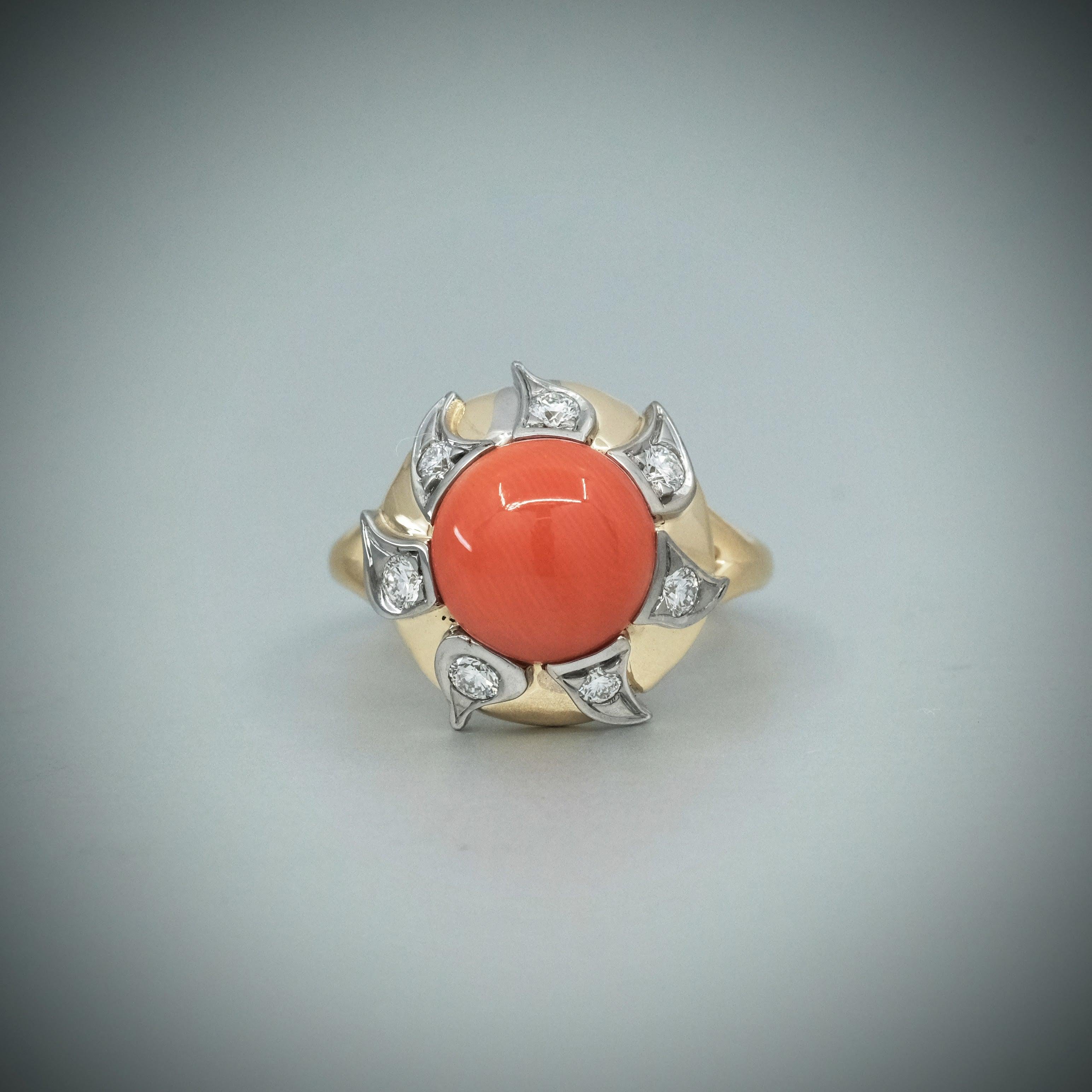 BUNDA Ring 'Lyra' aus roter Koralle und Diamanten. Dieser Ring besteht aus einem runden Cabochon aus roter Koralle von 3,39 Karat und runden Diamanten im Brillantschliff in 18 Karat Weiß- und Gelbgold.

Charakteristisch für den Corall: 1 = 3,39