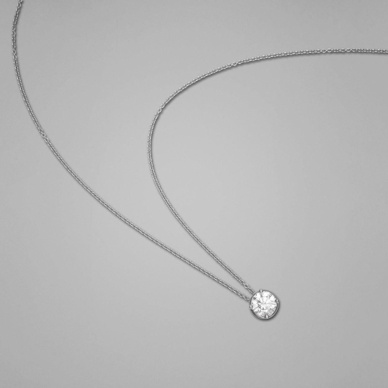 A BUNDA 'Bundova' Bezel Set Diamond Pendant, made in 18 carat white gold. Signed BUNDA.

Diamond Weight: .60ct round brilliant cut , F colour, Si2 clarity, GIA certified.