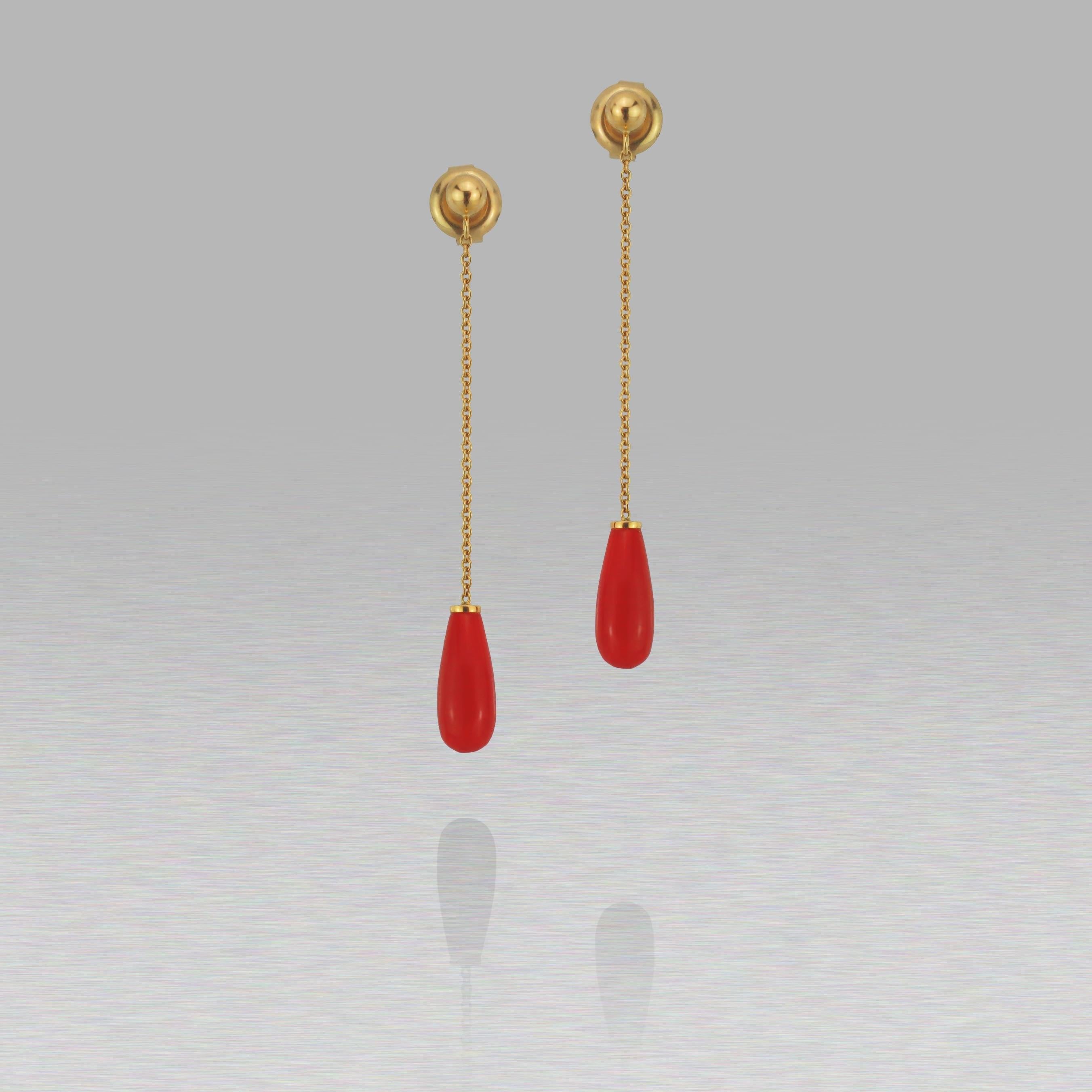These BUNDA 'Lacerta' coral earrings in 18ct yellow gold, feature orange coral drops, suspended with trace chain attached to 18ct yellow gold ball studs with post and butterfly fittings.