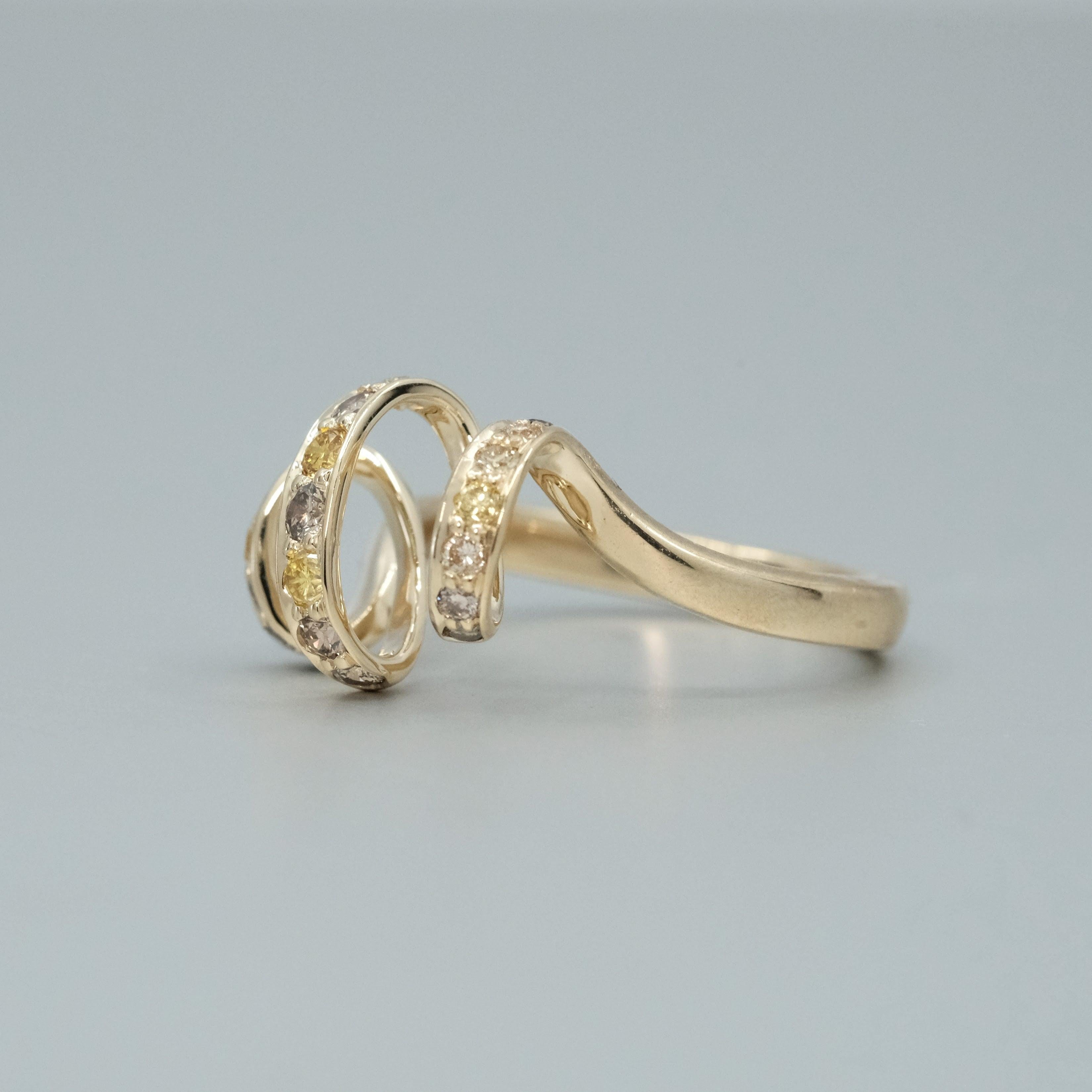 A BUNDA 'Lyra' diamond ring made in 18 carat yellow gold, set with yellow and cognac diamonds totalling 0.60ct. A very elegant ring.

Total Weight: 4.45g