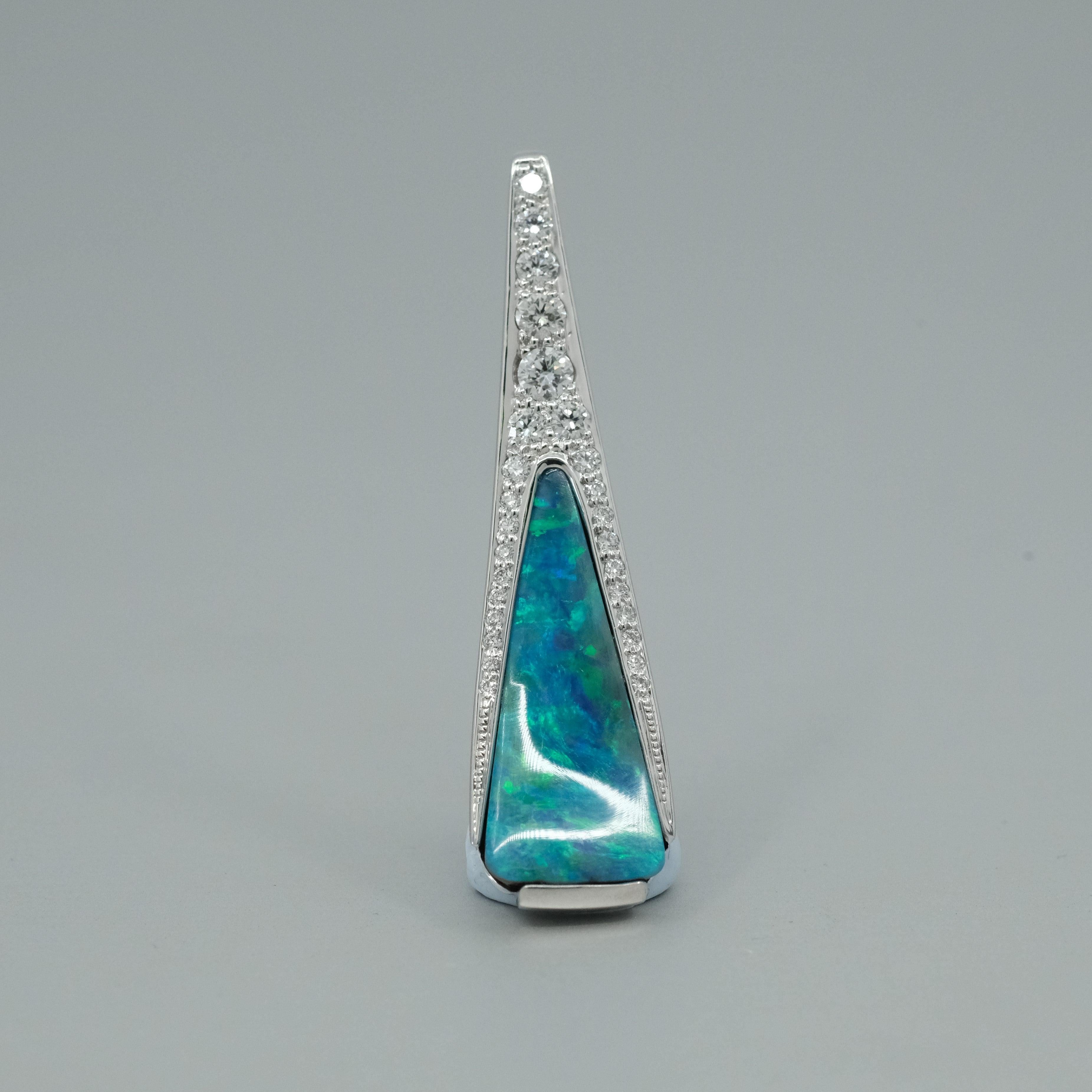 A BUNDA 'Caelum' Opal pendant made in 18 carat white gold. The boulder opal featuring with blue and
green colours enhanced with thread-set diamonds. Stamped BUNDA. Serial number 24010939.
Characteristics of Blue Context cut Boulder Opal; 1 = 5.25ct.
