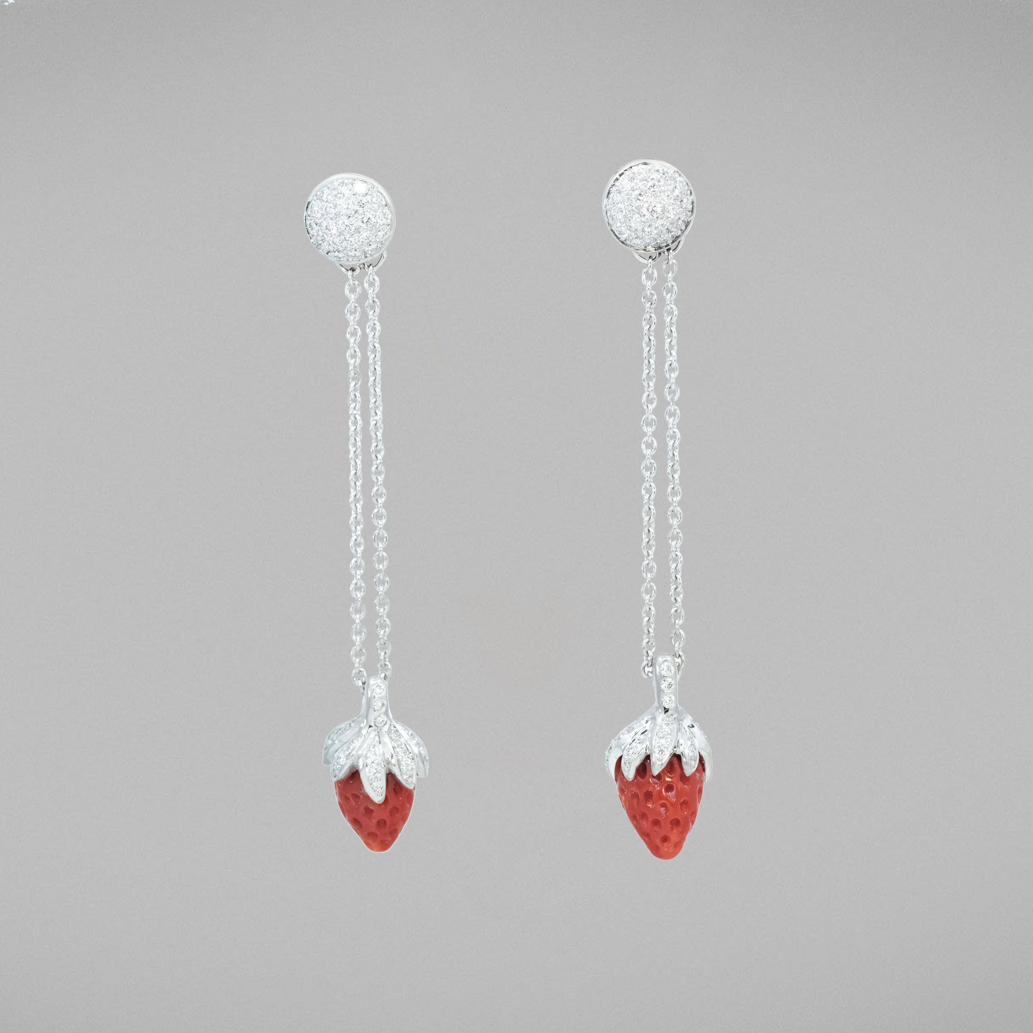 A BUNDA pair of 'Bundova' coral and diamond earrings in 18ct white gold. Signed BUNDA.
Characteristics of cut Corals; 2 = 7.61ct. strawberry shape
Characteristics of Round Brilliant Cut Diamonds: 104 = 1.09ct, F colour, VS Clarity
Total weight: 9.71