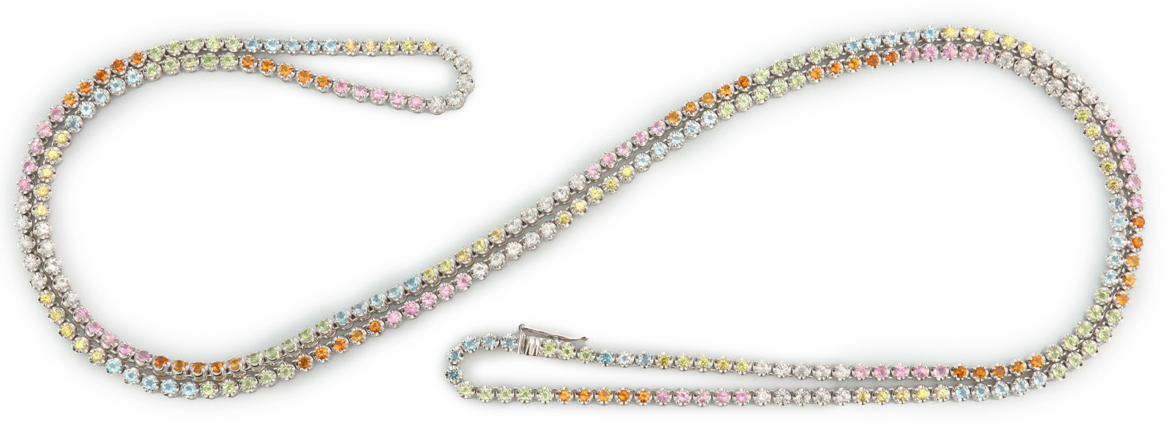 ’Tennis’ necklace set with the following gemstones: blue topaz, peridot, citrine, pink sapphire, white sapphire and yellow sapphire. 
Total carat weight of gemstones = 8.00ct. 
Necklace is 80cm long.
