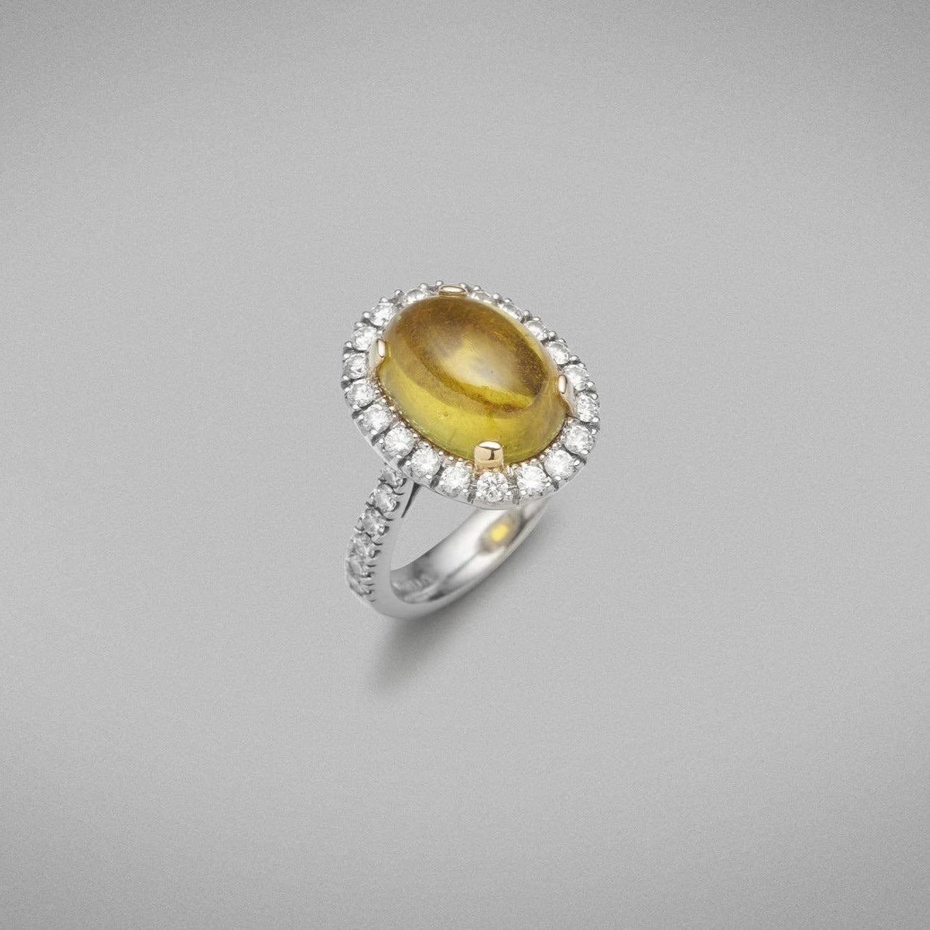 A BUNDA 'Valentin' Tourmaline and diamond ring in platinum and 18ct yellow gold, featuring a cabochon cut Tourmaline, surrounded with castle set round brilliant cut diamonds to the head and shoulders.

Weight of Tourmaline: 1 =