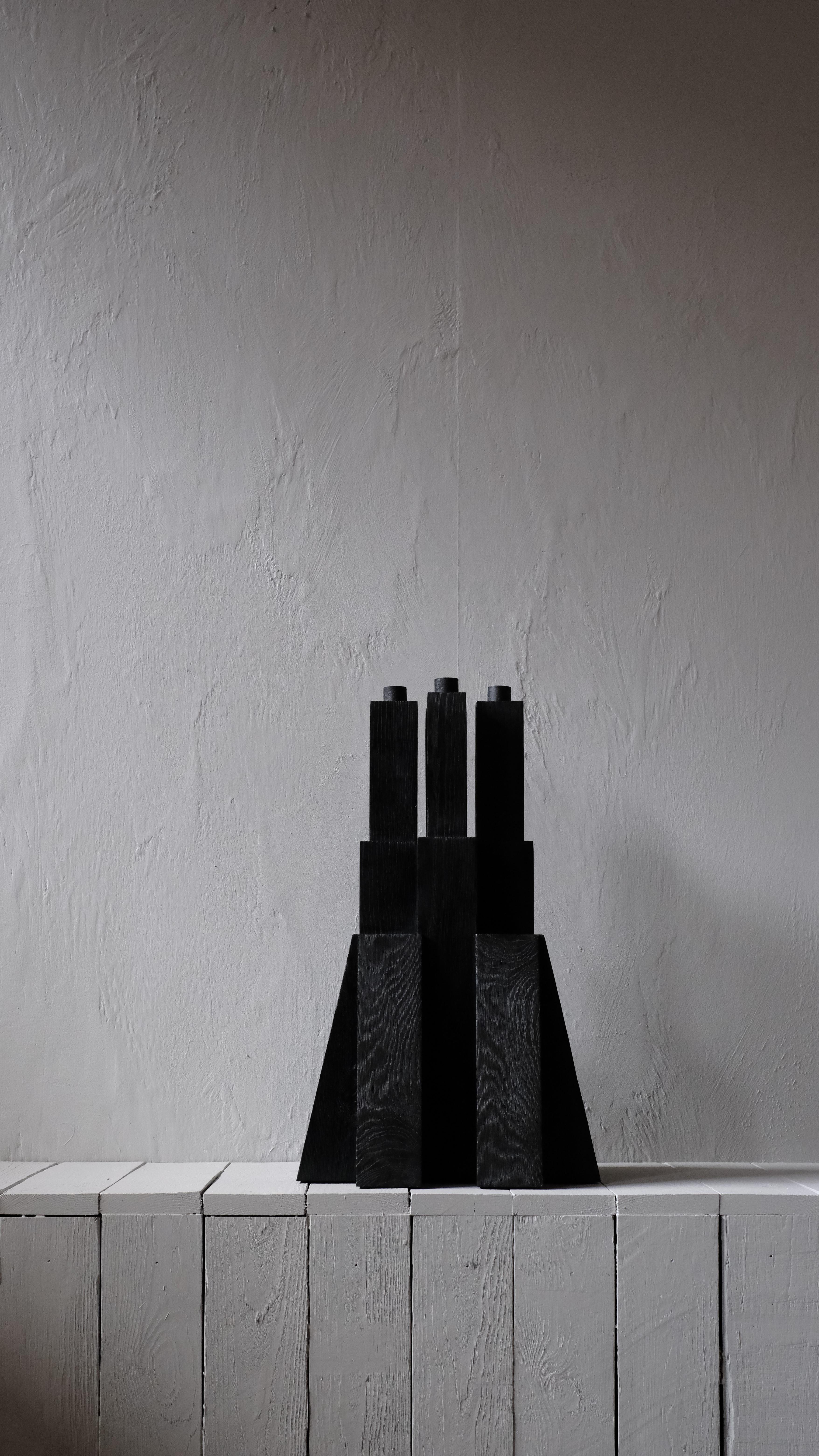 Bunker Candleholder 2.0 by Arno Declercq
Dimensions: W 32 x L 32 x H 52 cm 
Materials: Burned and waxed oak

Arno Declercq
Belgian designer and art dealer who makes bespoke objects with passion for design, atmosphere, history and Craft. Arno grew up