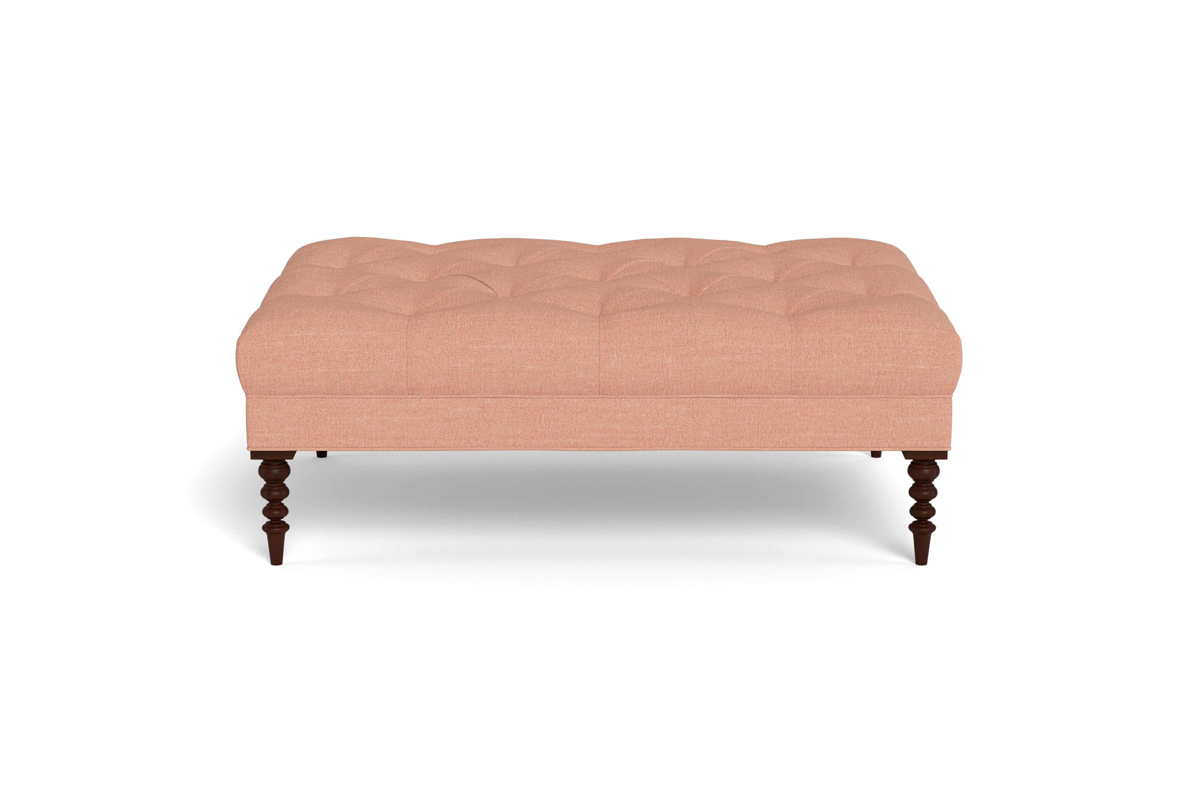 A large cocktail ottoman, with beautiful tufting set atop a trim upholstered box, with wonderfully turned legs. Made to order in adobe performance woven, a fabric able to be cleaned and used in high traffic areas.  Legs finished in mahogany. 