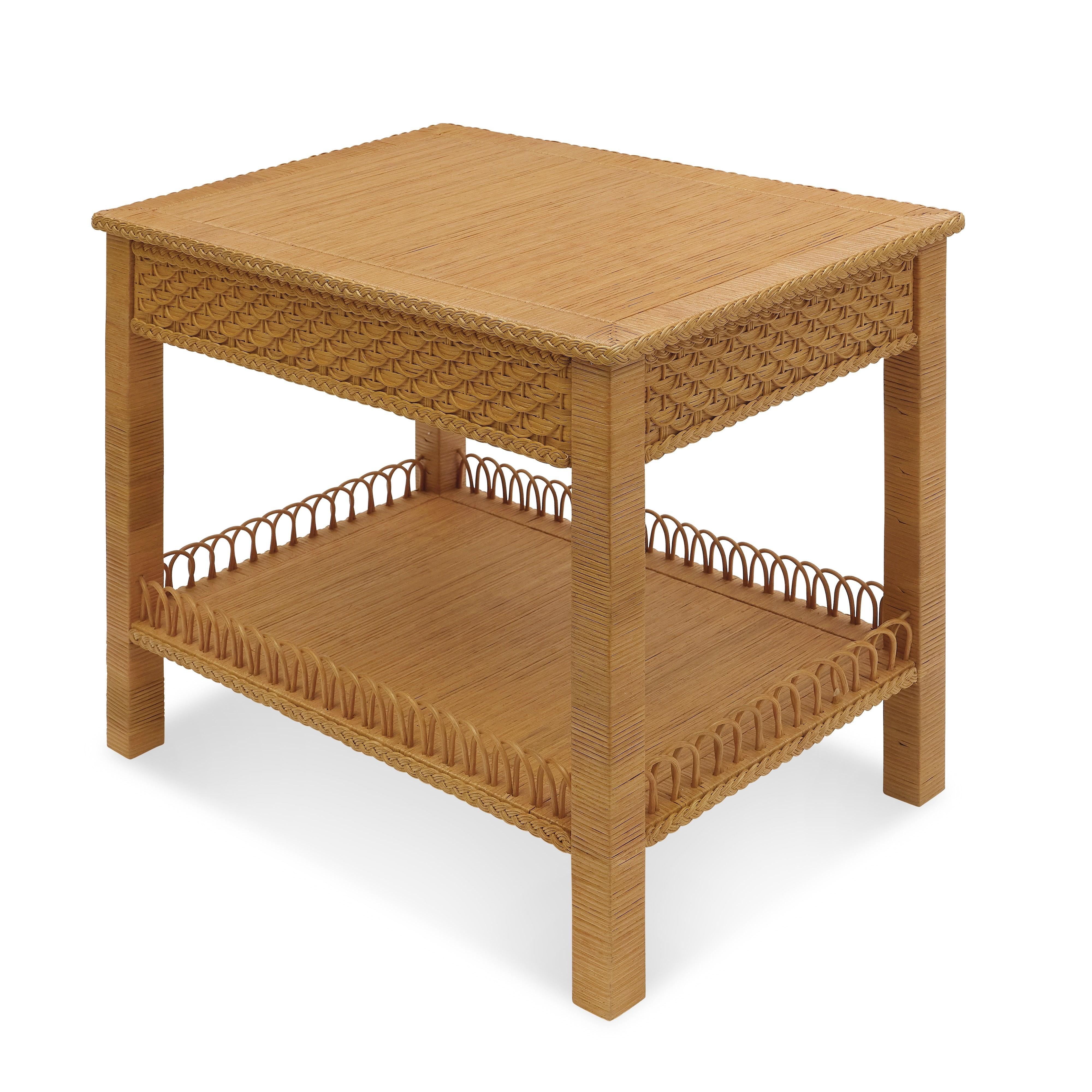 The Barbados Side Table highlights the artistry of wickerwork with a mix of intricate weaving techniques. Wrapped legs create a clean silhouette, while braided edges frame both the top and lower shelf. A fish-scale pattern adds texture to the upper