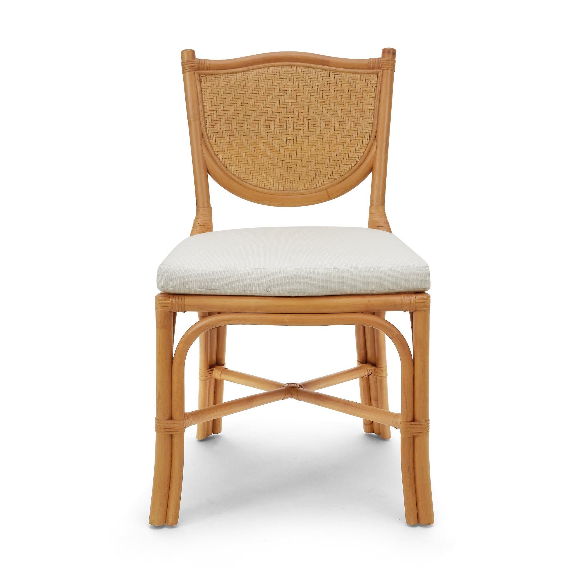 The Beatriz dining chair features a woven shield-shaped back and cruciform stretcher, and is comfortably upholstered with a neutral tie-on seat cushion. Equally at home pulled up to a desk or used around a dining or breakfast table.

- Natural