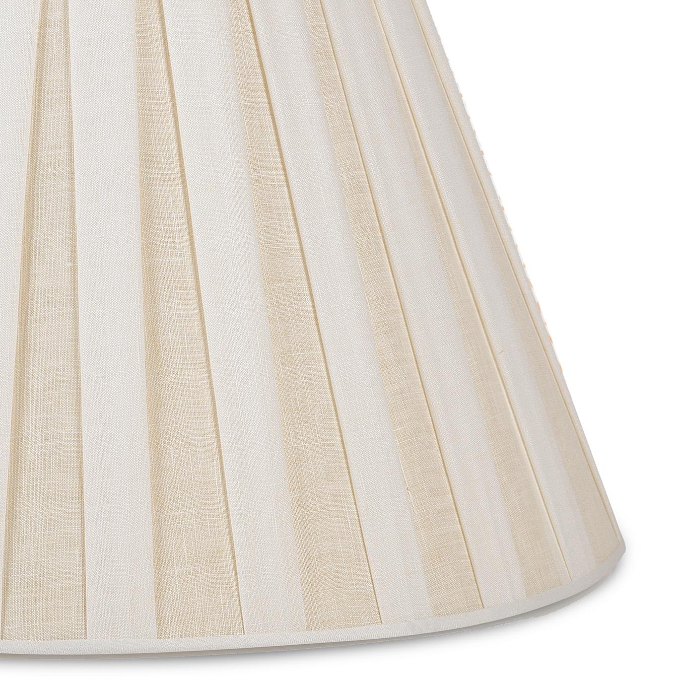 An off-white linen box pleat shade with interlining and self-trim at the top and bottom. It’s a classic style that adds understated texture and a charming glow when lit - warming any alcove it sits in. Scaled to work on nearly all of the Bunny