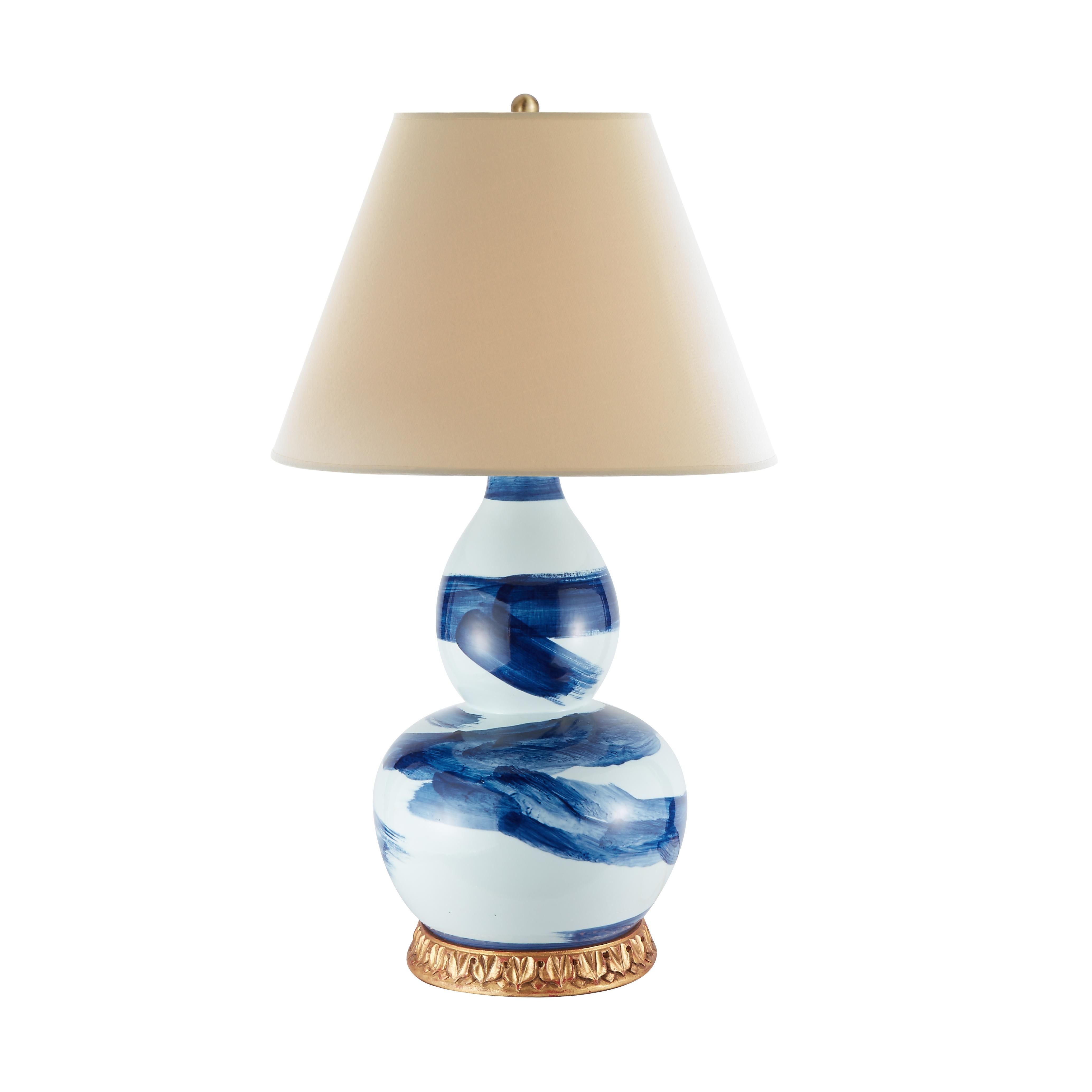Uninhibited brushstrokes bring a casual elegance to this classically shaped double gourd ceramic lamp. Generously sized, it’s a perfect to invigorate a desk in a home office or side table in a living room. It melds easily into any style, thanks to