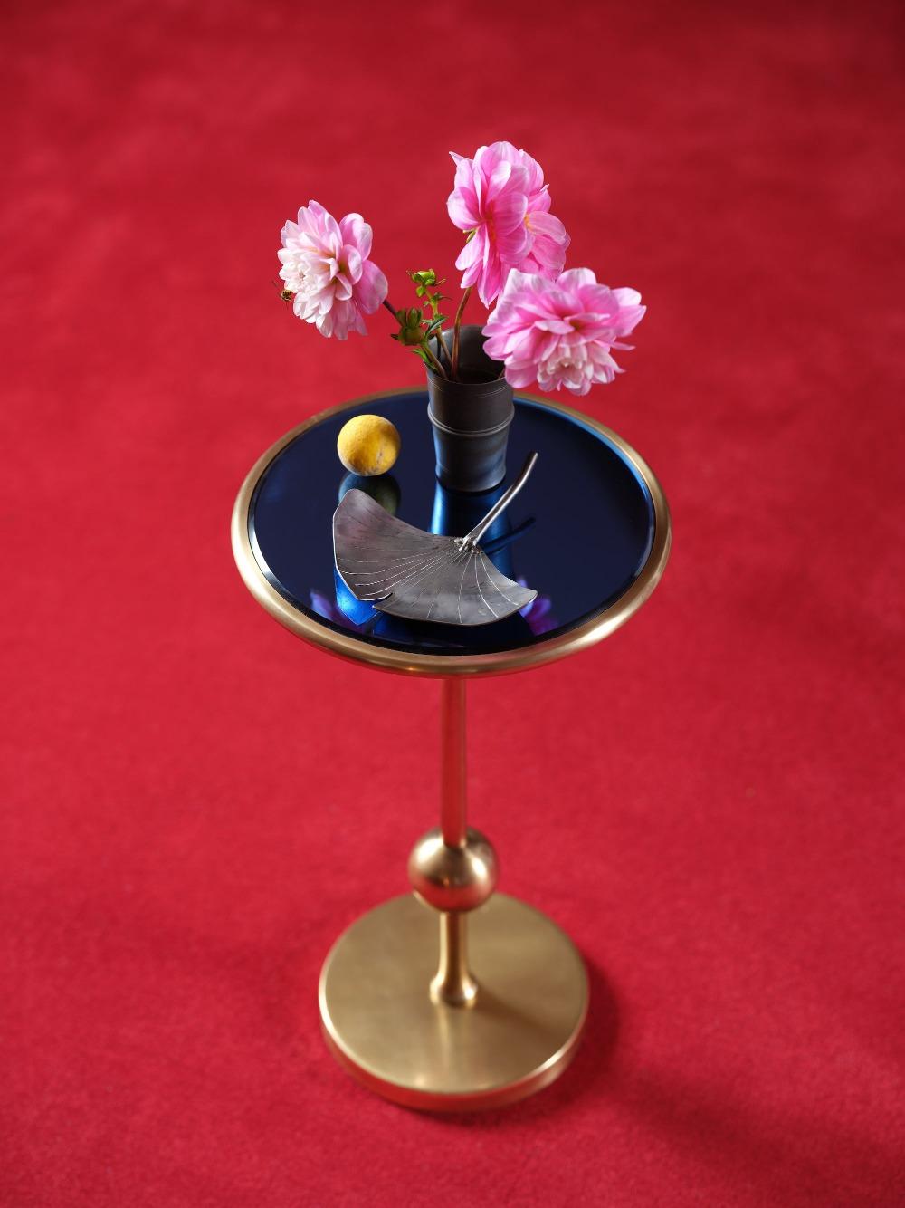 The slim, cosmic profile of the Burke drinks table is debonair for any number of interiors, with a slim post surmounted by a sphere suspended over the crisp base. Two mirrored choices, blue or silver, mean you might want more than one. Brass with a