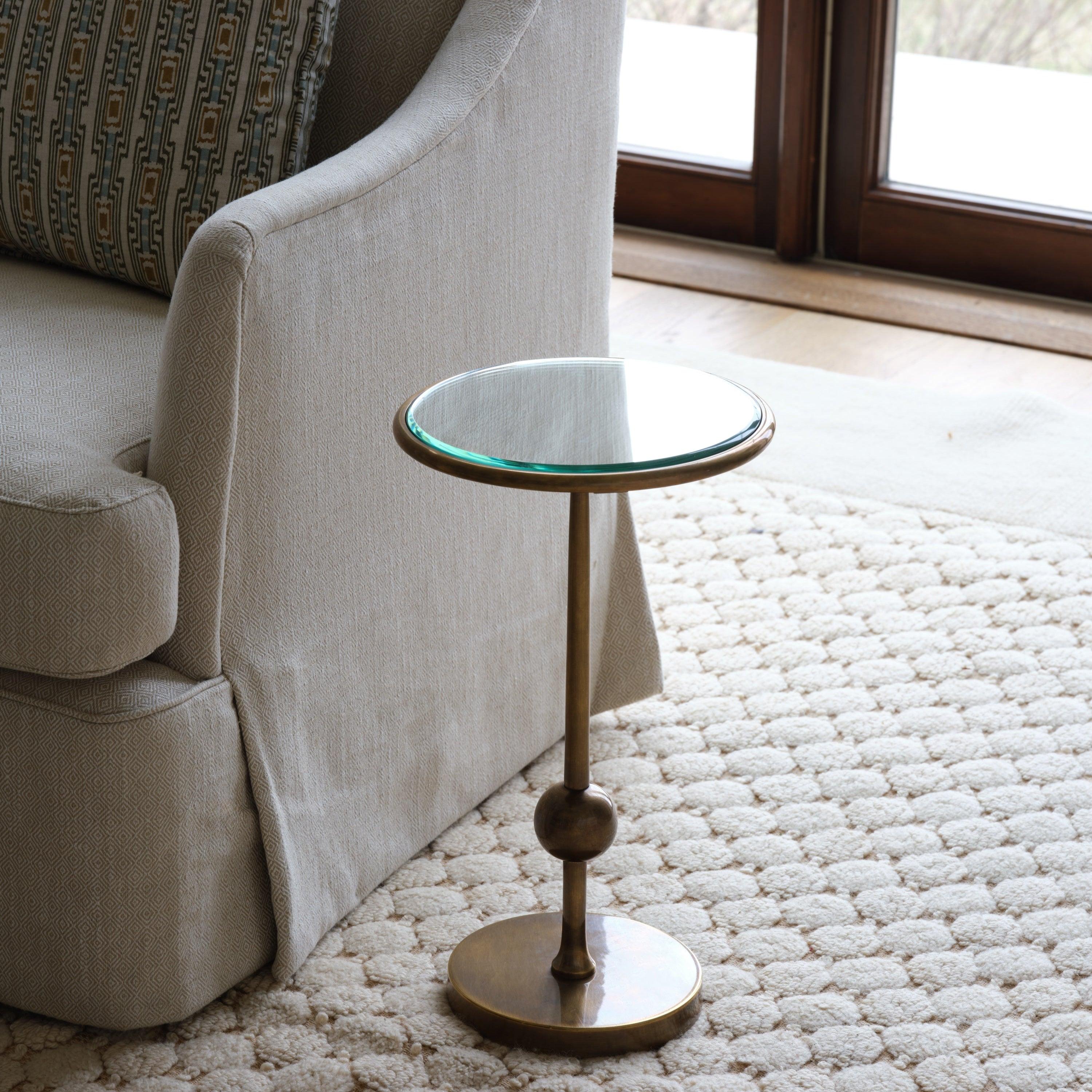The slim, cosmic profile of the Burke Drinks Table is debonair for any number of interiors, with a slim post surmounted by a sphere suspended over the crisp base. Two mirrored choices, blue or silver, mean you might want more than one. Brass with a