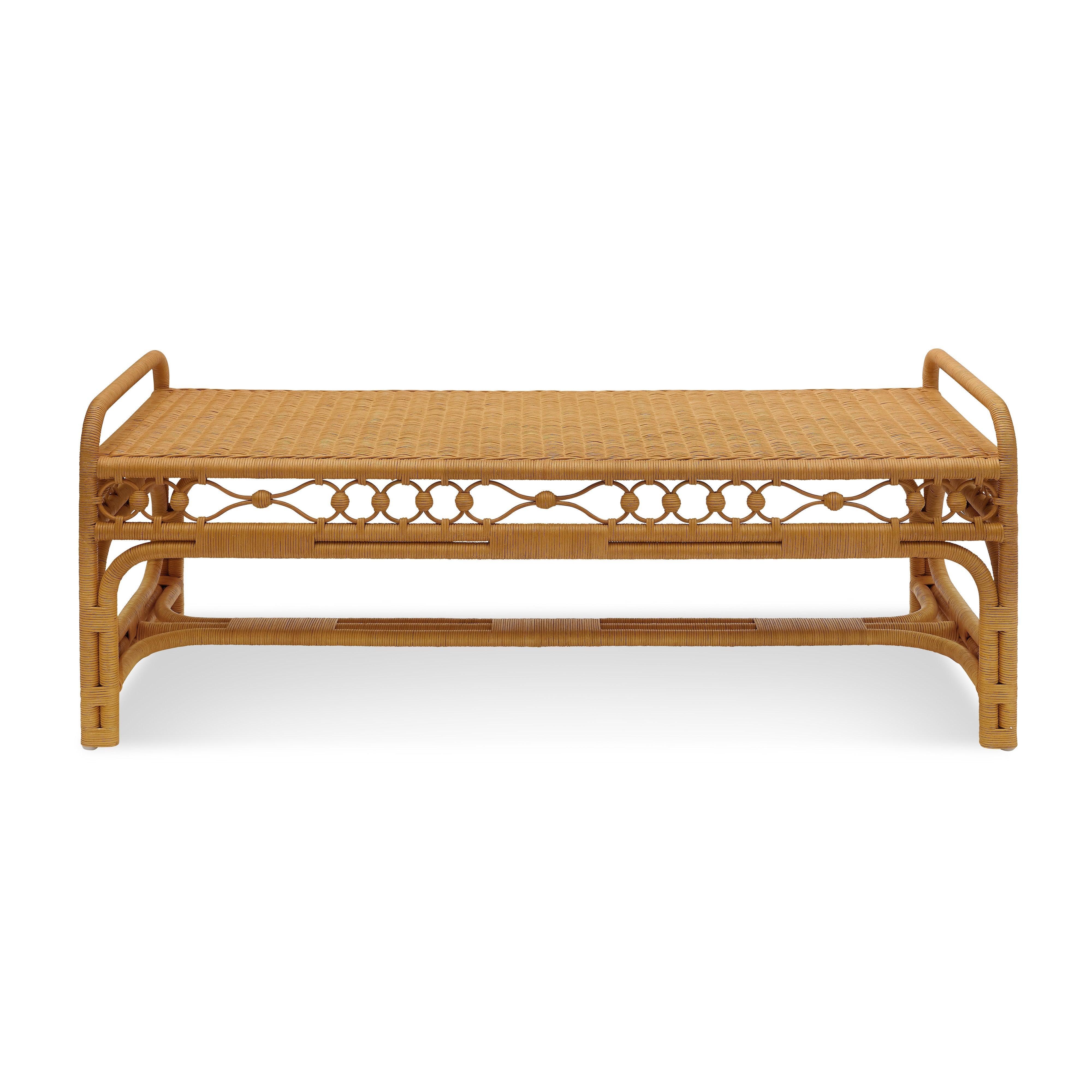 A showcase of masterful wickerwork, the Carlisle Bench is woven from natural rattan with an intricate apron detail of interlocking rings, lending a sculptural quality to its airy silhouette. The gently curved arms and layered weaving techniques add