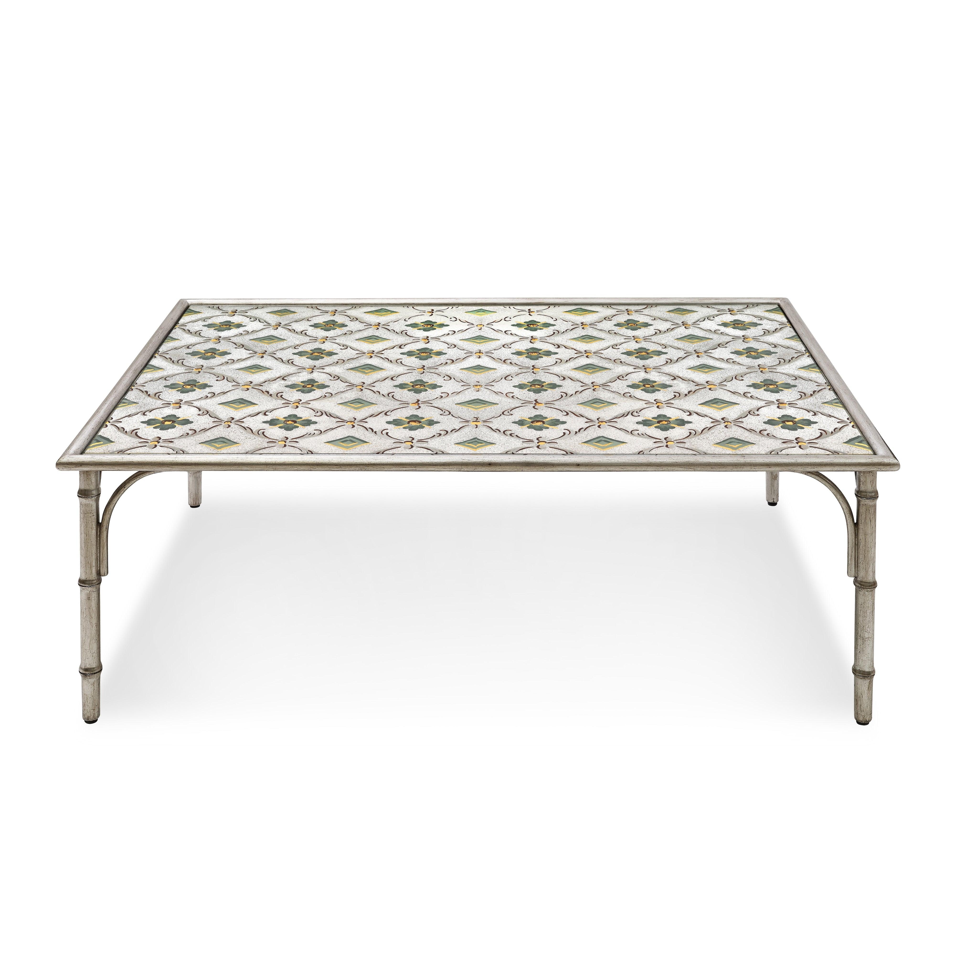 A study in understated glamour, the Celine Coffee Table will be the crown jewel of any seating group. Its antiqued mirrored glass top—hand-painted on the reverse with a floral lattice pattern—uses the old technique of eglomise in a modern way. A