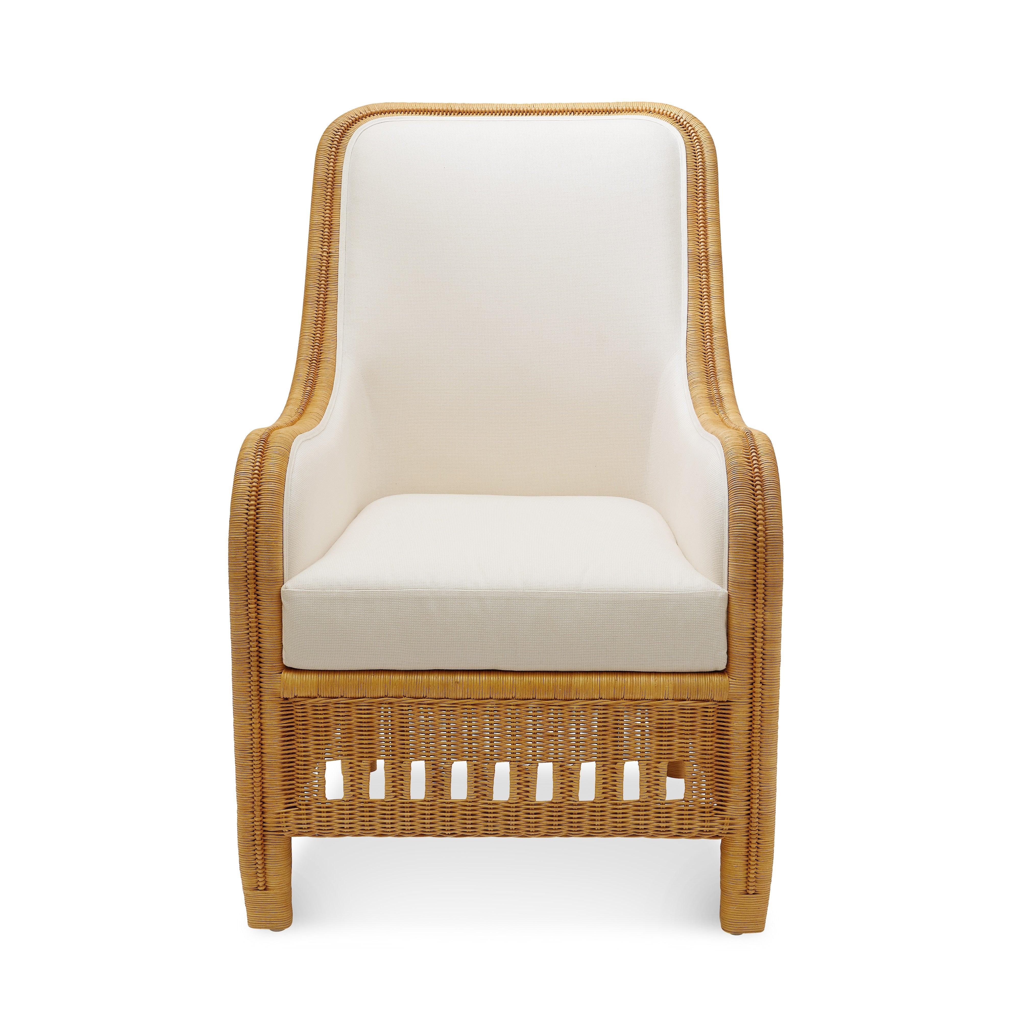 Graceful curves and impeccable craftsmanship define the Charleston Armchair, a modern interpretation of an early 20th-century antique. Woven natural rattan frames an upholstered back and arms, while a removable seat cushion in Sunbrella’s Natte