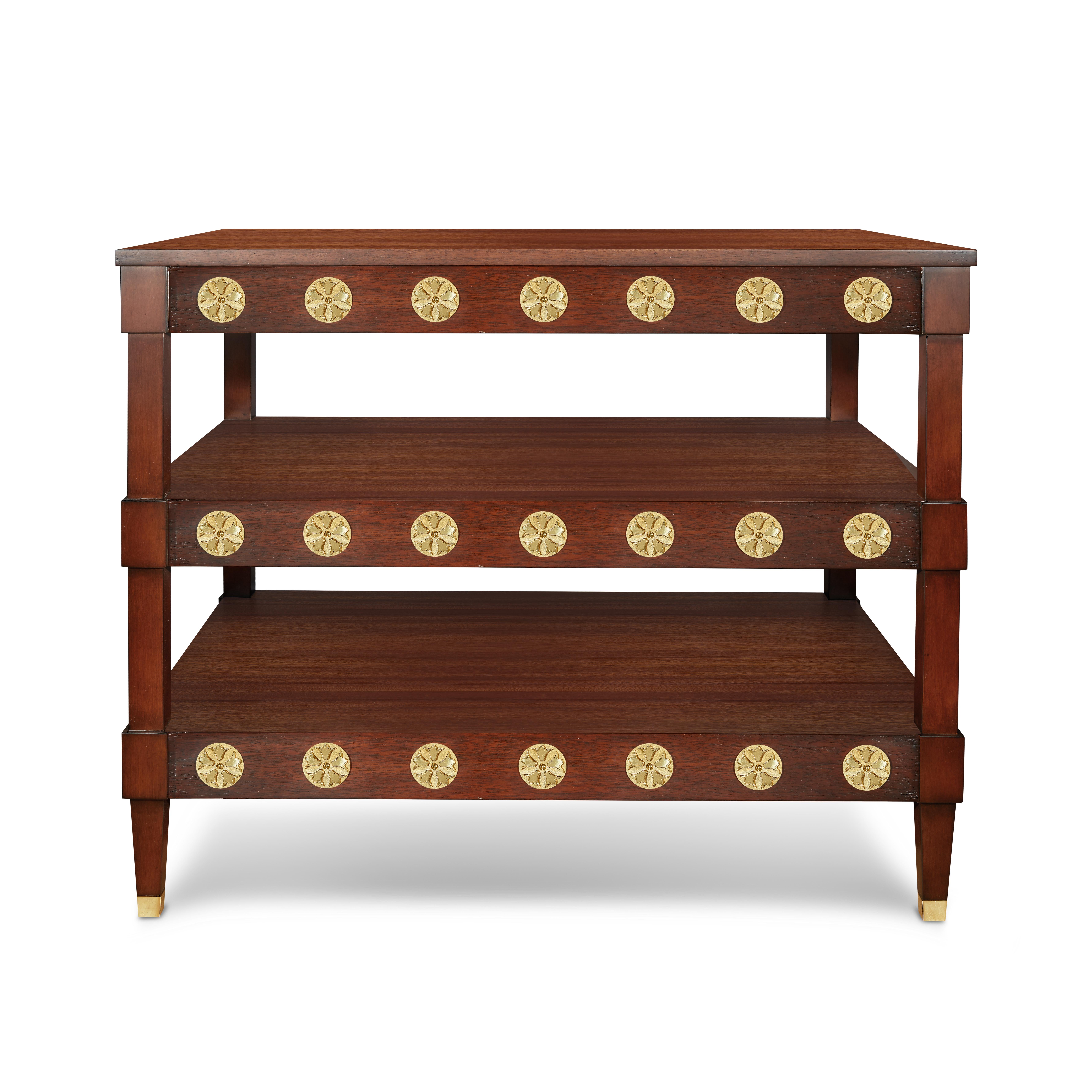 A generously scaled three-tiered table, ideal for use in a library to display your favorite books, or perhaps as a capacious bedside table when paired with a king-size bed. The Duncan table features a mahogany-color finish and refined brass details
