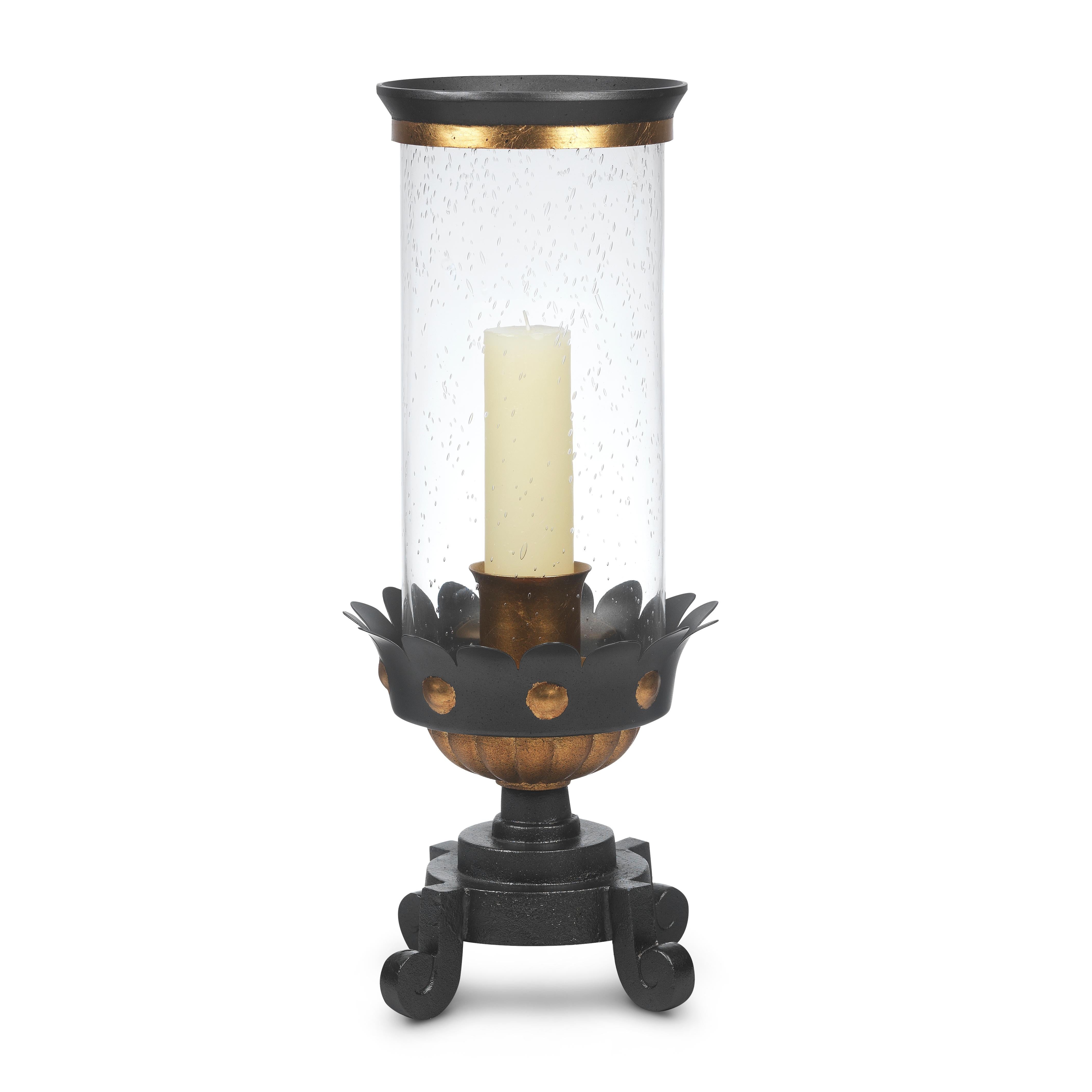 The parcel gilt, gadrooned and stylized floret body defines this 1940s-inspired hurricane. A weighted forged iron base supports the metal-capped glass shade. Accommodates a 2