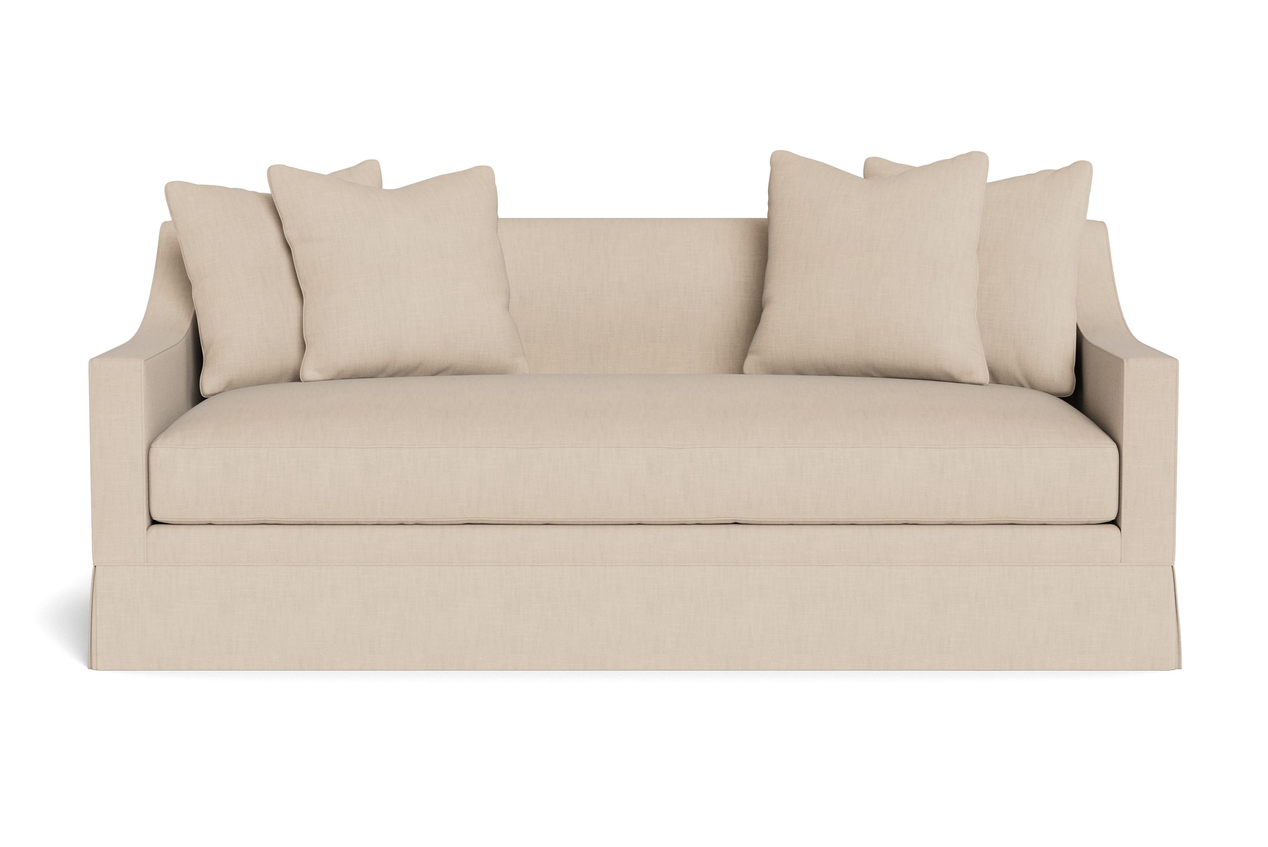 Un beau canapé moderne à jupe avec des accoudoirs inclinés. Un coussin d'assise unique et quatre coussins de 21
