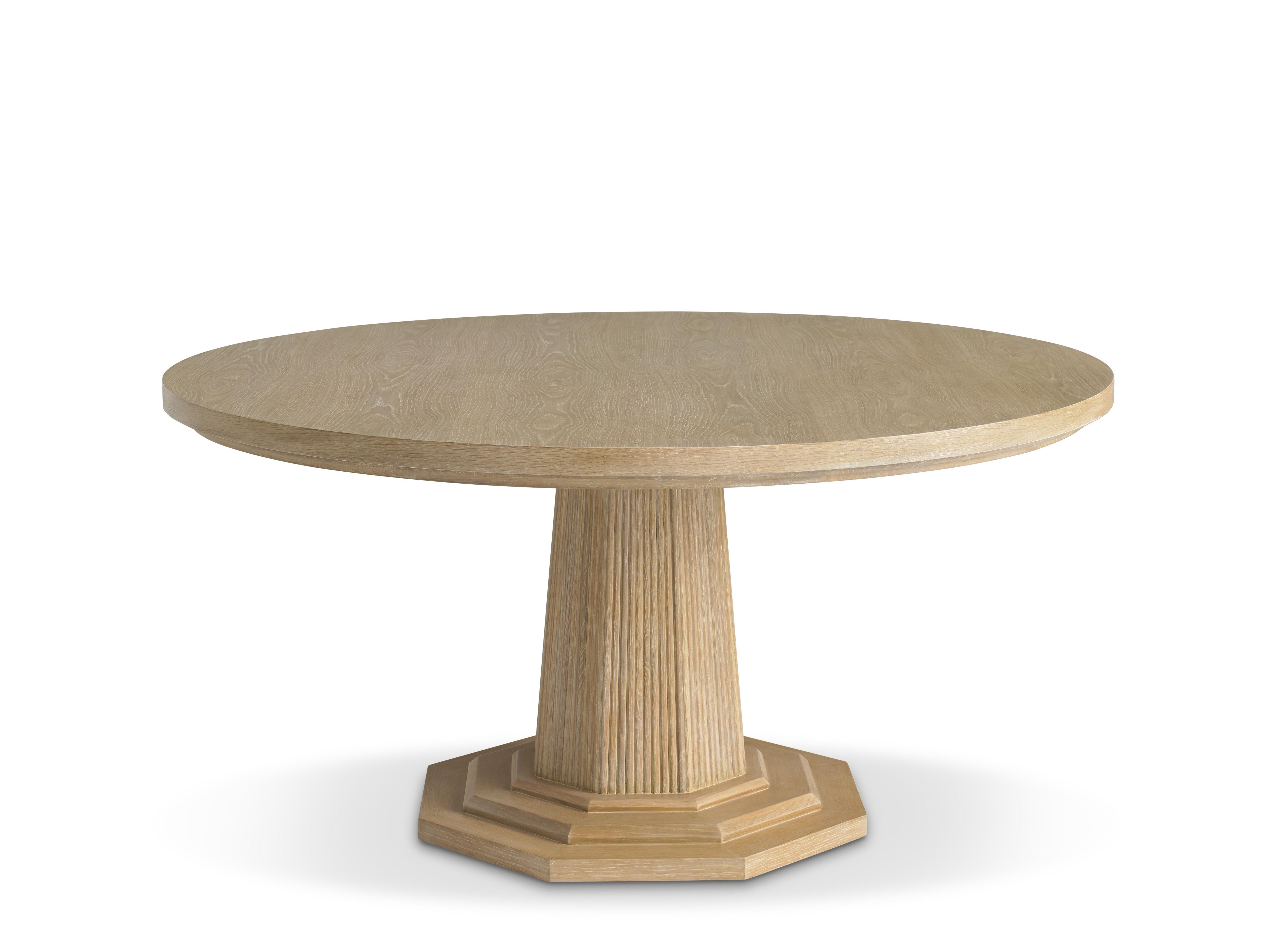 This large-scale 60” diameter dining table has a top and base finished in cerused oak. The pedestal base is reeded and octagonal in shape. This piece is made for people to live around - it anchors a room and will comfortably seat a houseful of