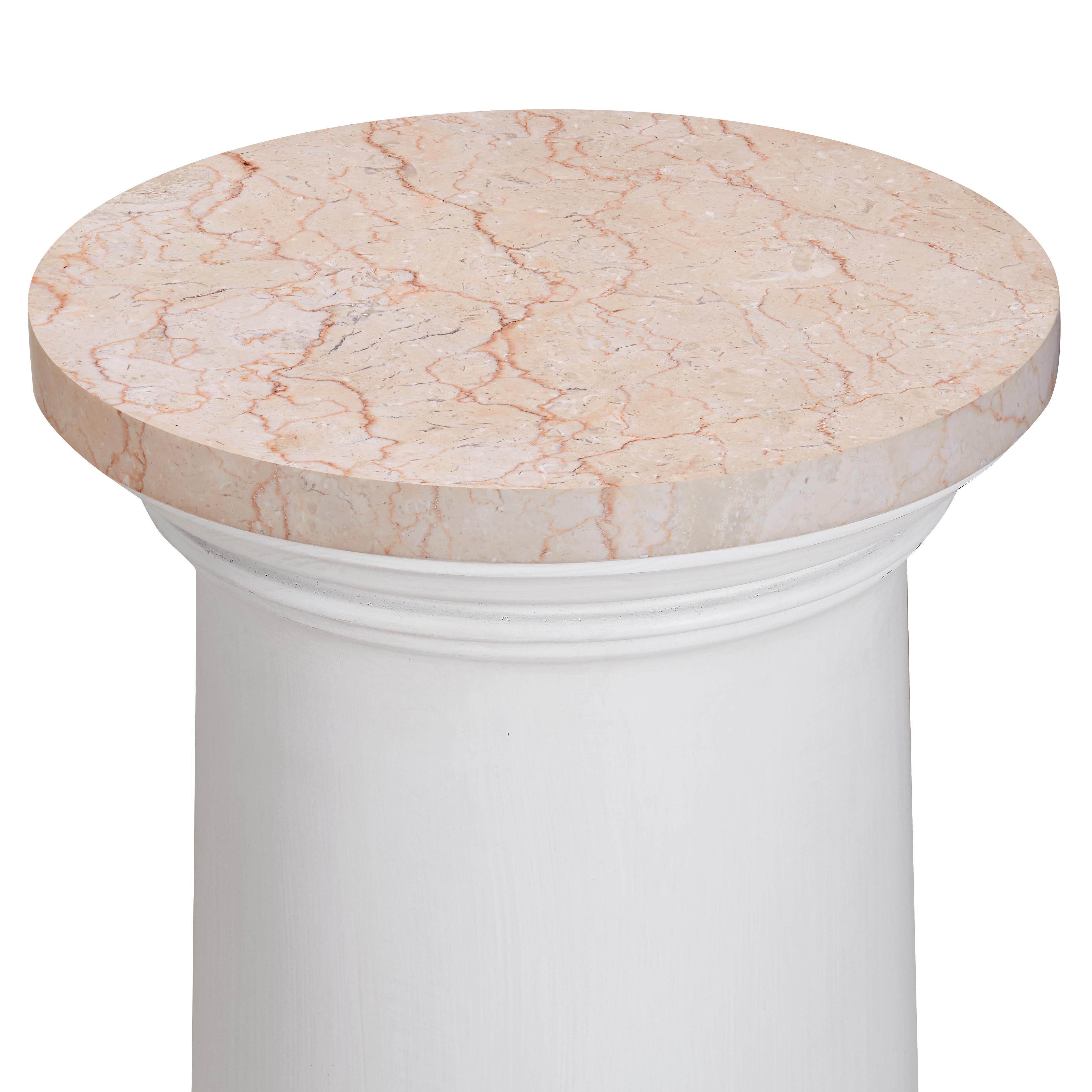 A circular pedestal drinks table, with a calm, chalk white painted finish. Its capital top shows off a honed marble perfectly scaled for a morning cup of coffee or afternoon cocktail. Octagonal base.   Suitable for use indoors or on a covered porch,