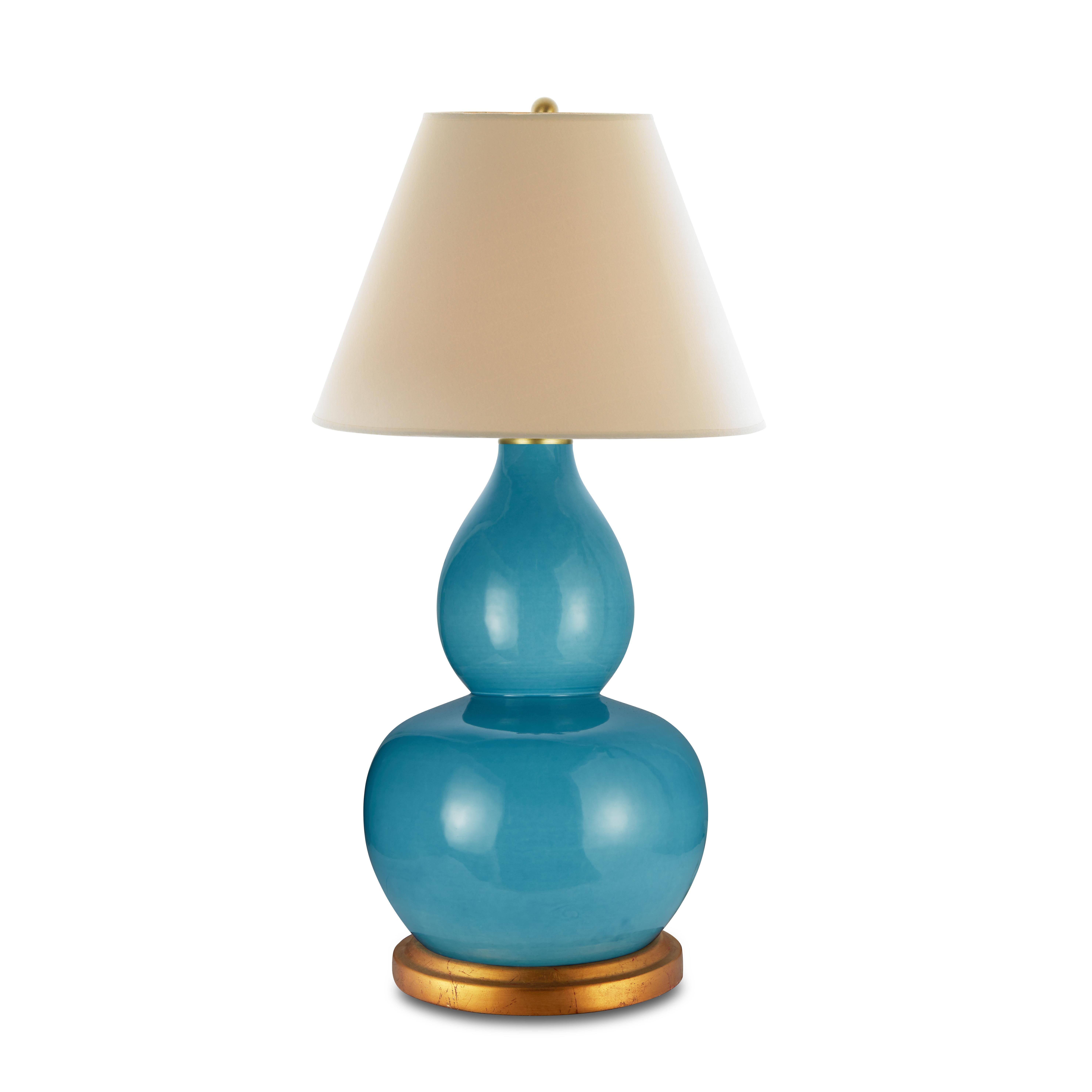 “Color is essential to life,” says Bunny. This spirited double gourd lamp brings the joyful essence of Caribbean Sea right into your home, and the gold gilt wedding band base enhances the striking blue color. Pair this lamp with mossy greens or