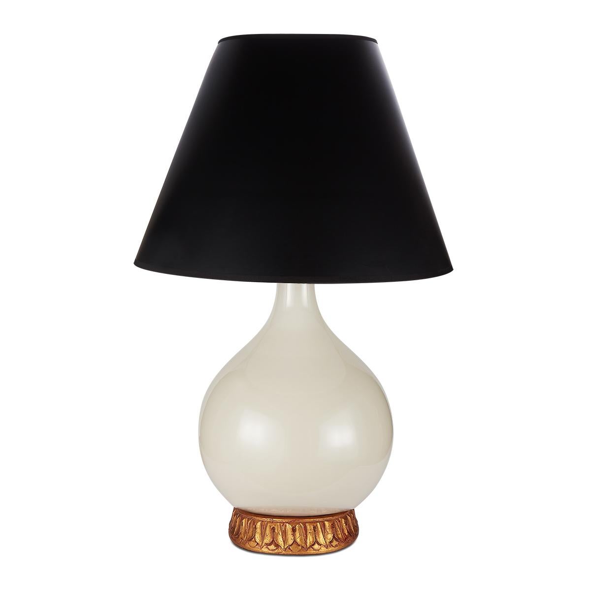 The pearl, with its extraordinary luster and shape, inspired our newest ceramic lamp. Its drop-shaped body tapers at the neck, where the rich glaze reveals--just slightly--red undertones which give depth to the white glaze belly. The ceramic body is