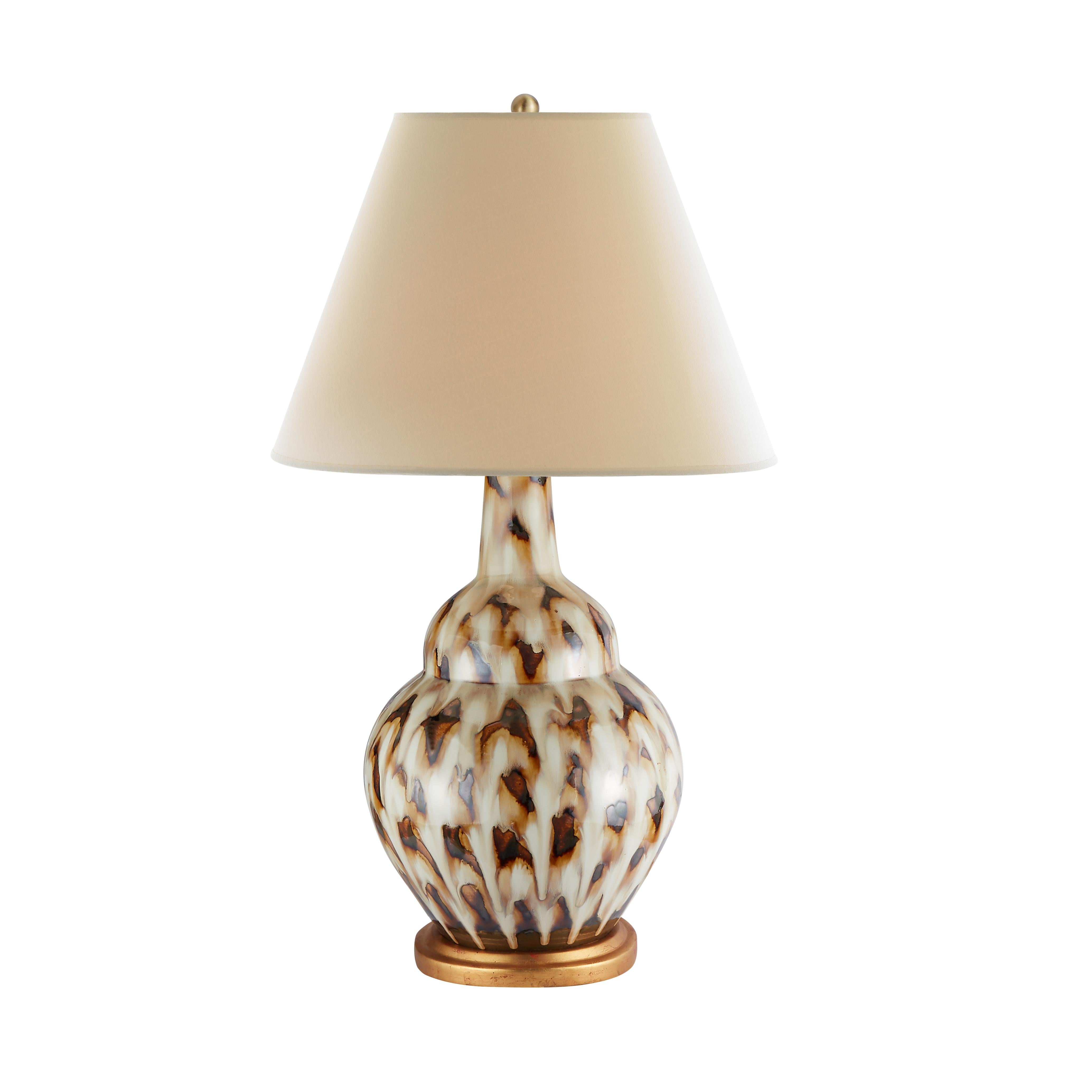 The classical silhouette of our Pheasant Feather lamp adds a graceful, subdued ambiance to any side table. The lamp’s ceramic vase is hand-painted in warm brown tones before a final glazing and firing to produce this stunning allover pattern. It is