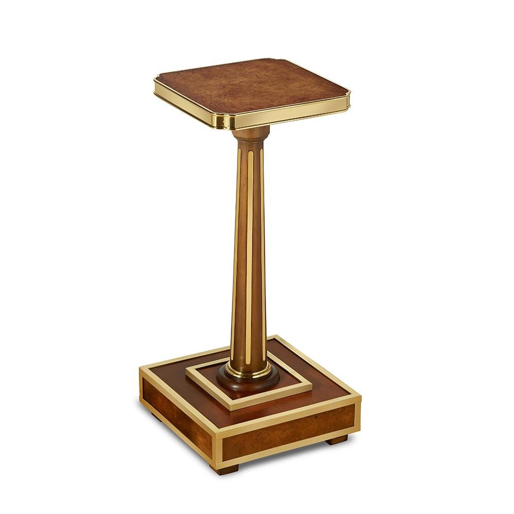 A contemporary interpretation of the Louis XVI style, this drink table’s beautiful brass trim and warm wood veneer would suit a variety of interior styles.
