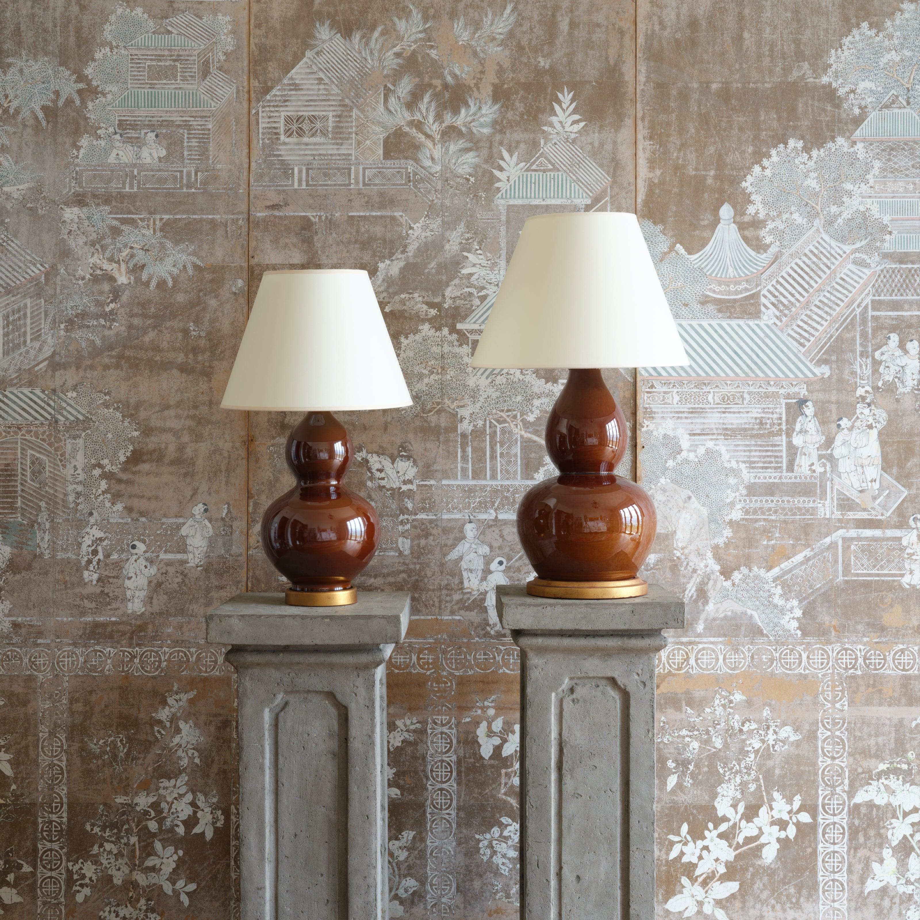 A smaller version of our popular Cinnamon Lamp. A rich cinnamon glaze is applied to a classic double-gourd form and set atop a gold wedding band base.

Recommended lampshade side: 15” x 8” x 11” 
Lampshade not included.

- Glazed ceramic, carved