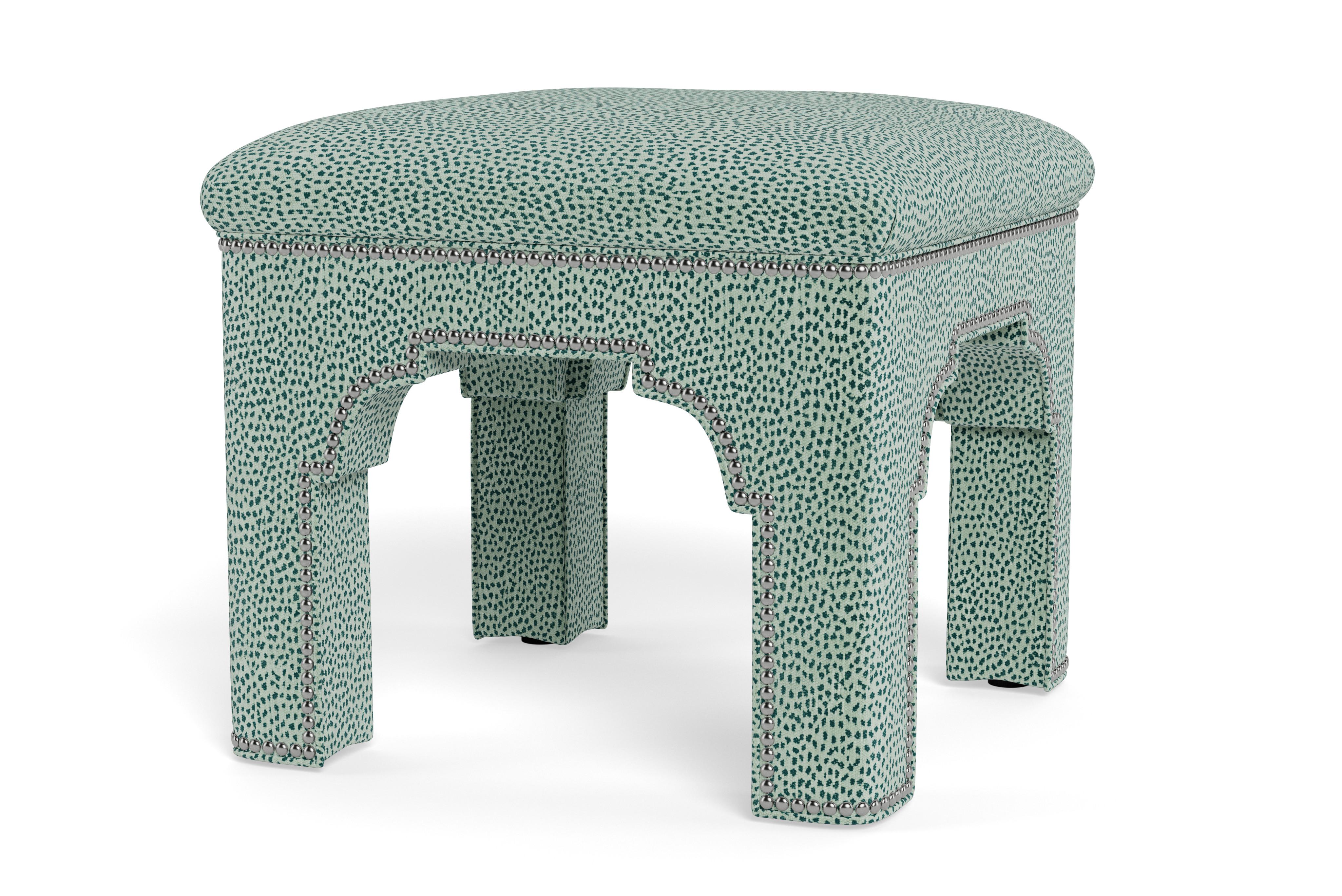 Add a chic accent to any room with this compact stool on its own or displayed in pairs.  Made to order in teal leopard chenille with antique nickel nail heads. The tightly upholstered seat covers a solid maple frame. A Mughal-inspired arch make it a