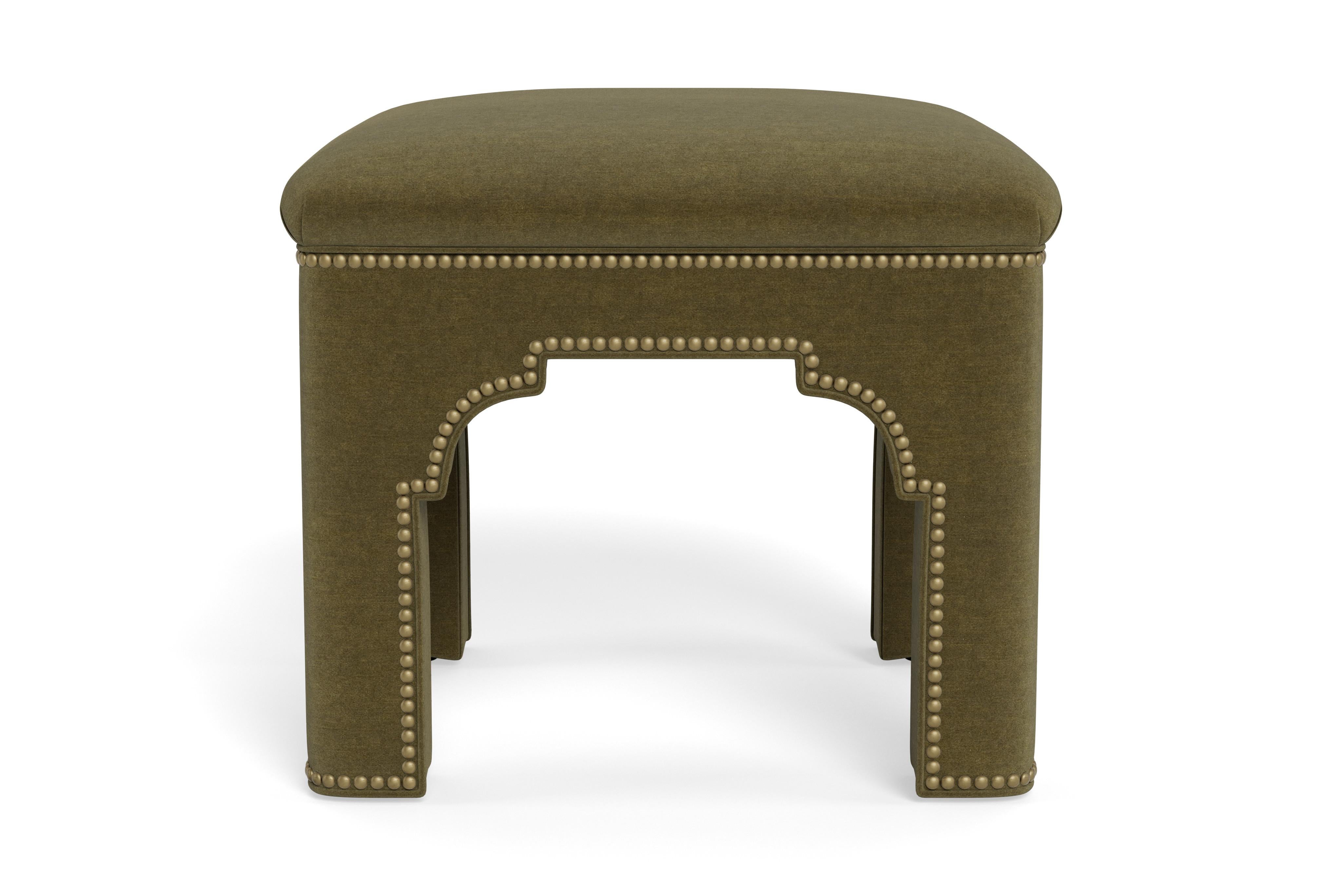 Add a chic accent to any room with this compact stool on its own or displayed in pairs.  Made to order with antique brass nail heads accenting moss performance velvet, a fabric that can be cleaned and withstand high traffic areas. The tightly