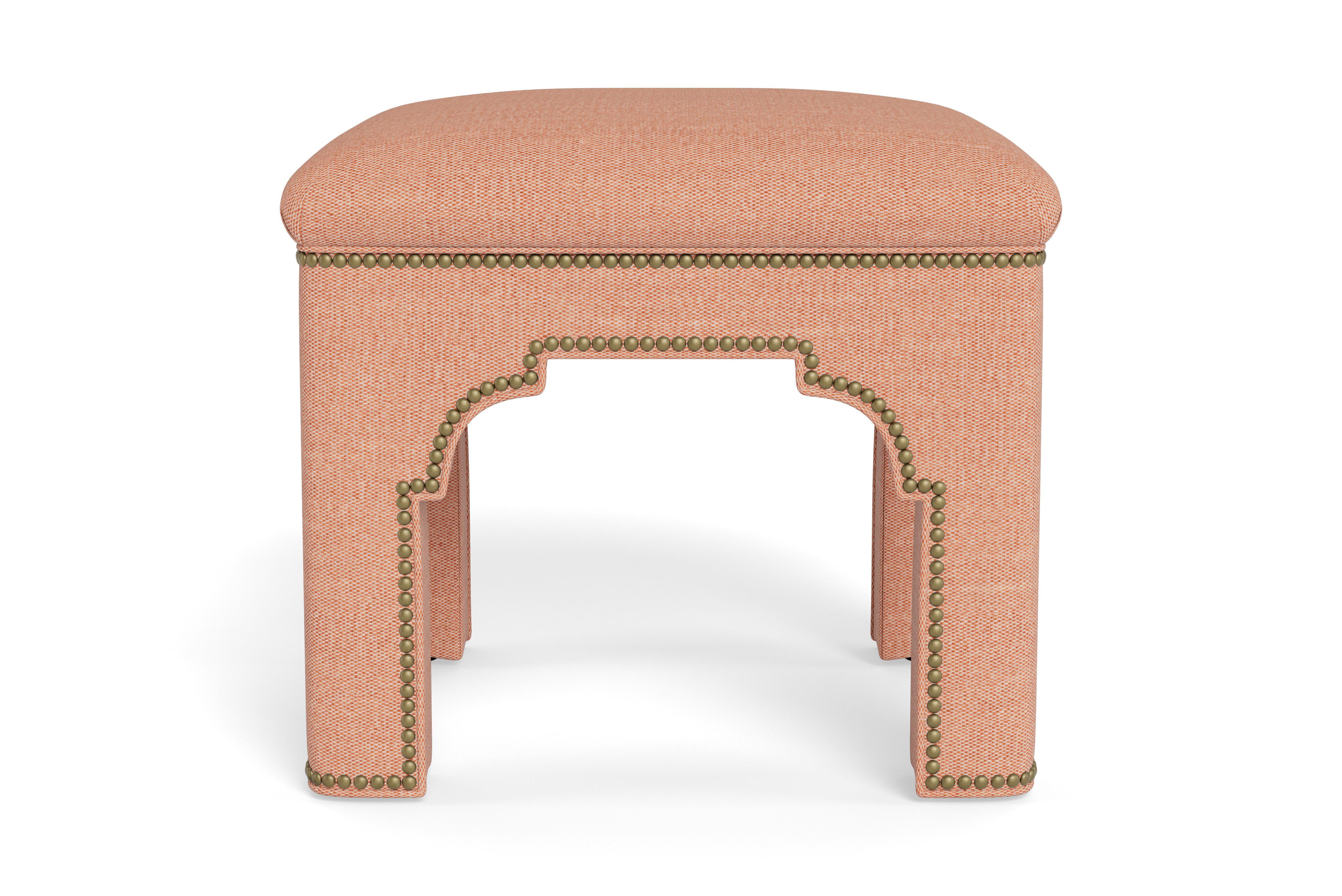 Add a chic accent to any room with this compact stool on its own or displayed in pairs.  Made to order with antique brass nail heads accenting adobe performance linen, a fabric that can be cleaned and withstand high traffic areas. The tightly