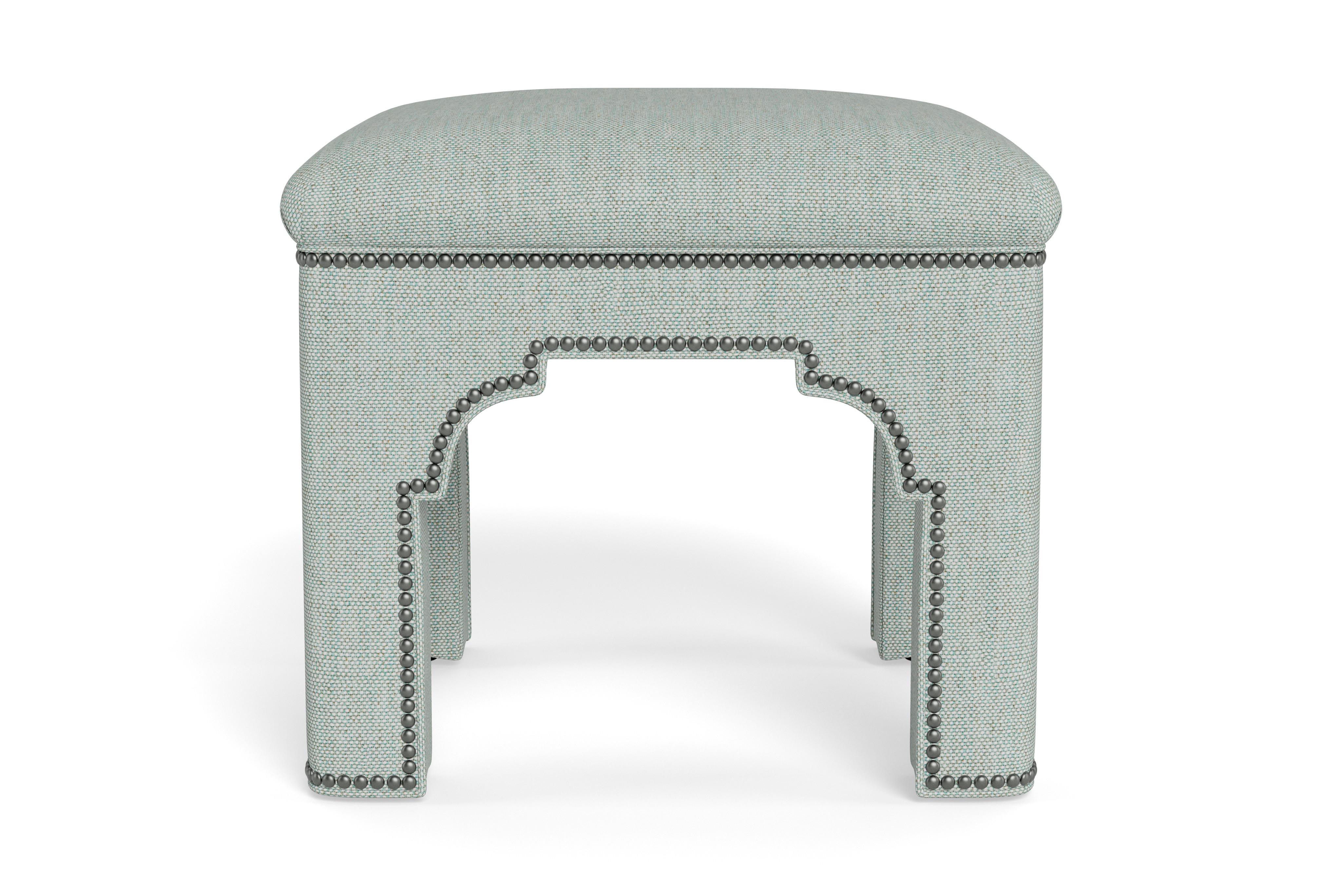 Add a chic accent to any room with this compact stool on its own or displayed in pairs.  Made to order with bronze nail heads accenting seafoam performance linen, a fabric that can be cleaned and withstand high traffic areas. The tightly upholstered
