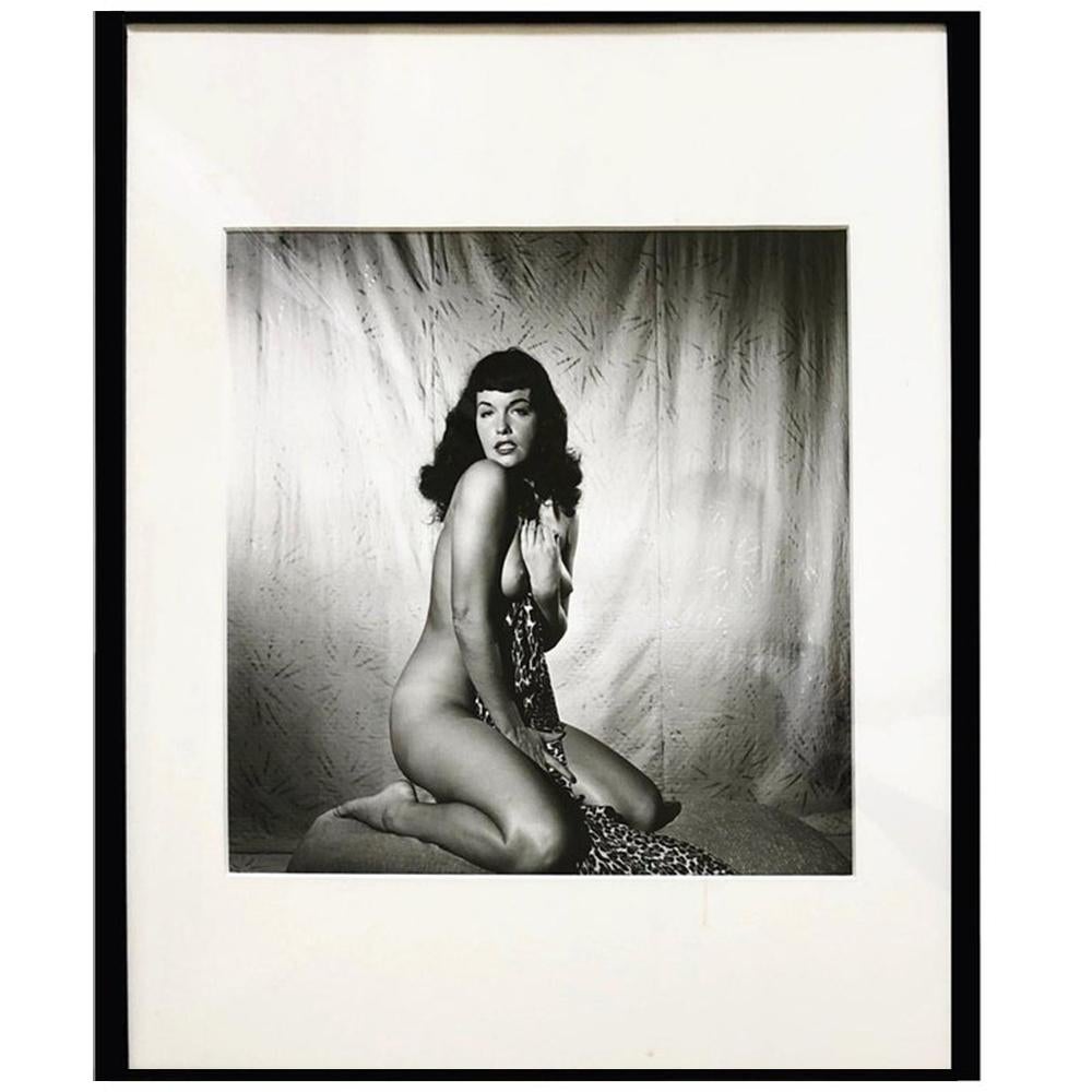 Bunny Yeager Portrait Photograph - Bettie Page Clutching Robe, 1954 Framed