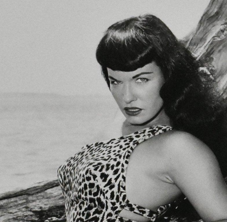 Bettie Page with Driftwood, Key Biscayne, Florida, 1954 by Bunny Yeager
Photographed in 1954
Printed in 2013
Gelatin Silver Print
Image size: 19 in. H x 18.75 in. W
Sheet size: 24 in. H x 20 in. W
Frame size: 33 in. H x 27 in. W 
Edition 2 of