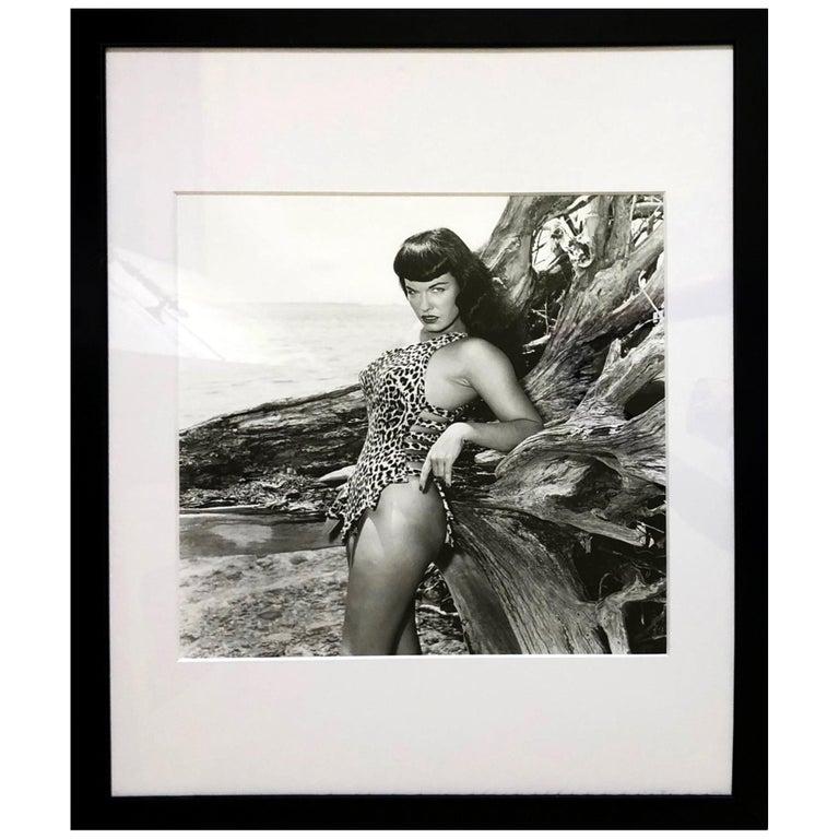 Bettie Page with Driftwood, Key Biscayne, FL, 1954 (Framed) - Photograph by Bunny Yeager