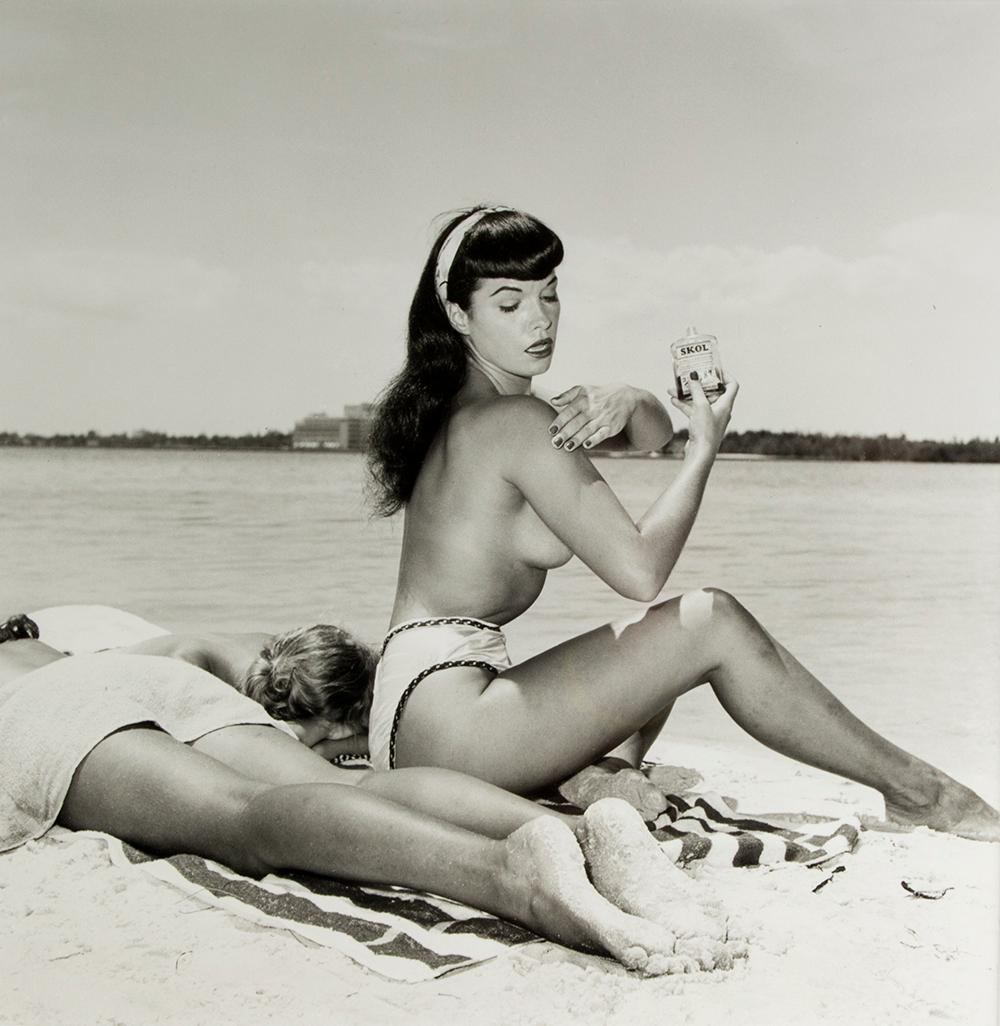 Bunny Yeager Nude Photograph - Bettie Page with Friends, Applying Suntan Lotion