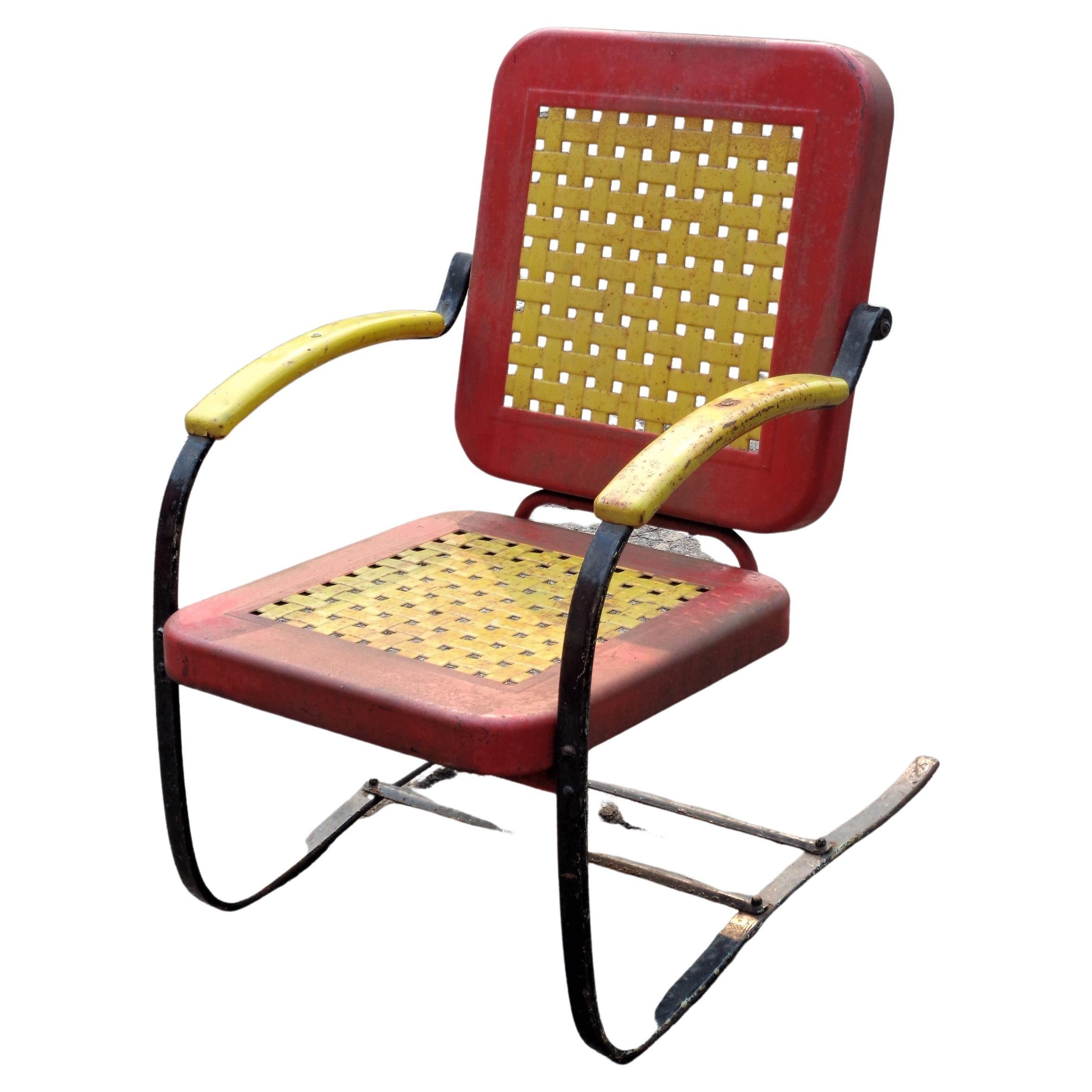 American Art Deco iron cantilever base floating rocking chair w/ beautifully shaped woven basket design seat and back rest in original glowing yellow, red and black factory enamel painted surface by the Bunting Glider Co. / stamped signed in metal