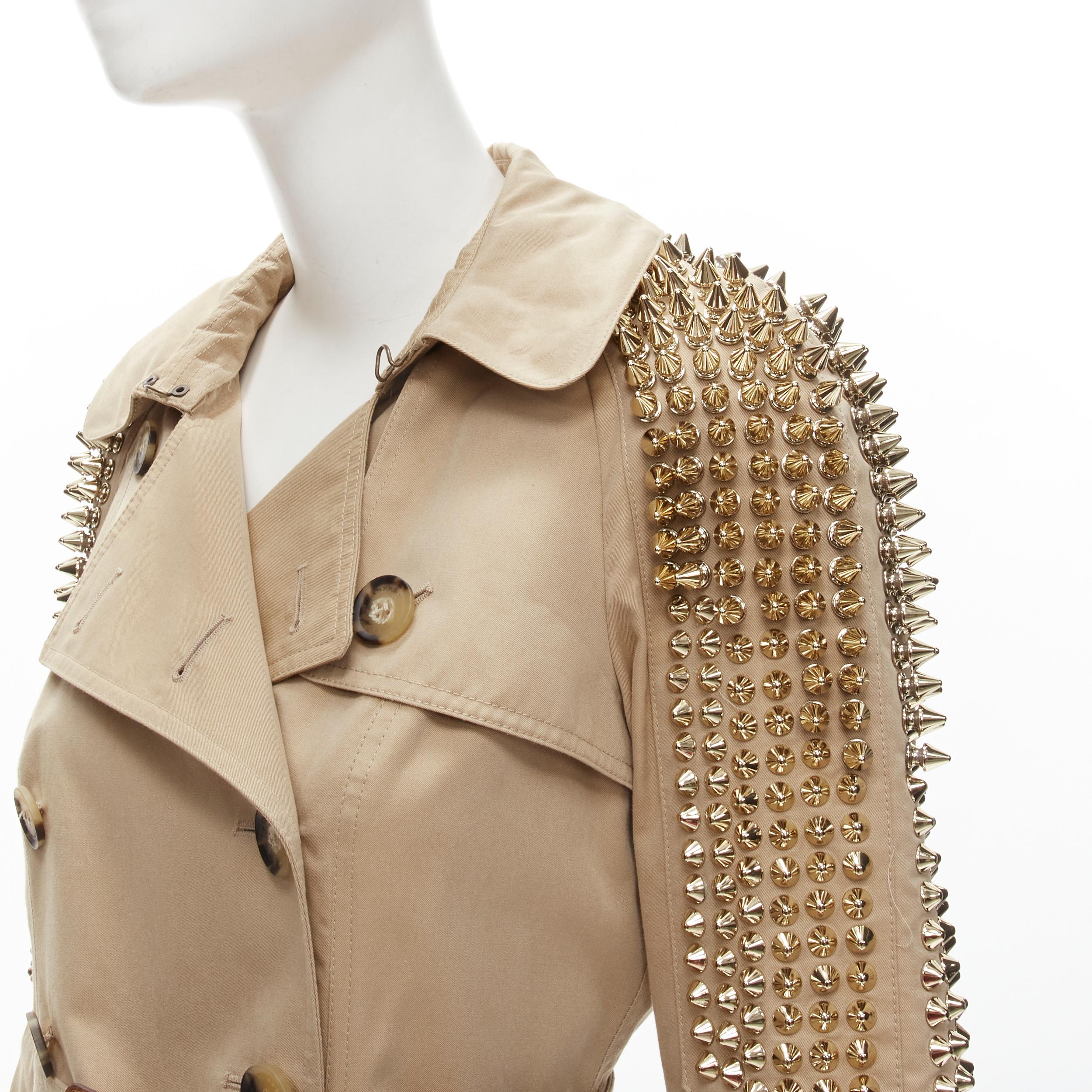 BURBERRY 2011 Iconic Punk gold spike stud cotton belted trench coat IT38 XS 
Reference: TGAS/C01238 
Brand: Burberry 
Designer: Christopher Bailey 
Collection: 2011 Runway 
Material: Cotton 
Color: Beige 
Pattern: Solid 
Closure: Button 
Extra