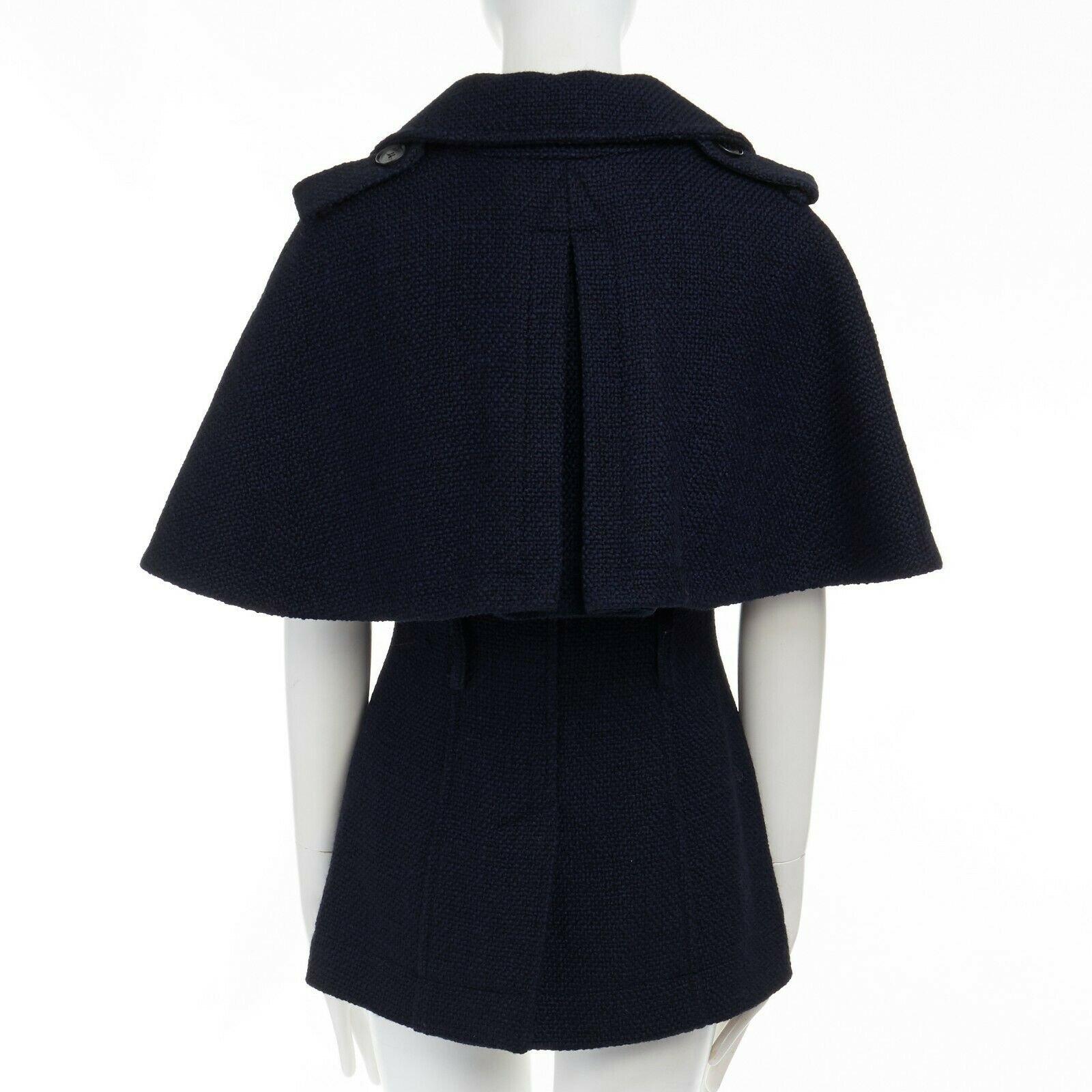 BURBERRY 2012 Wilderly 100% virgin wool cape double breasted trench jacket XS 
Reference: TGAS/A02929 
Brand: Burberry 
Designer: Christopher Bailey 
Collection: Fall Winter 2012 
Material: Virgin Wool 
Color: Navy 
Pattern: Solid 
Extra Detail: