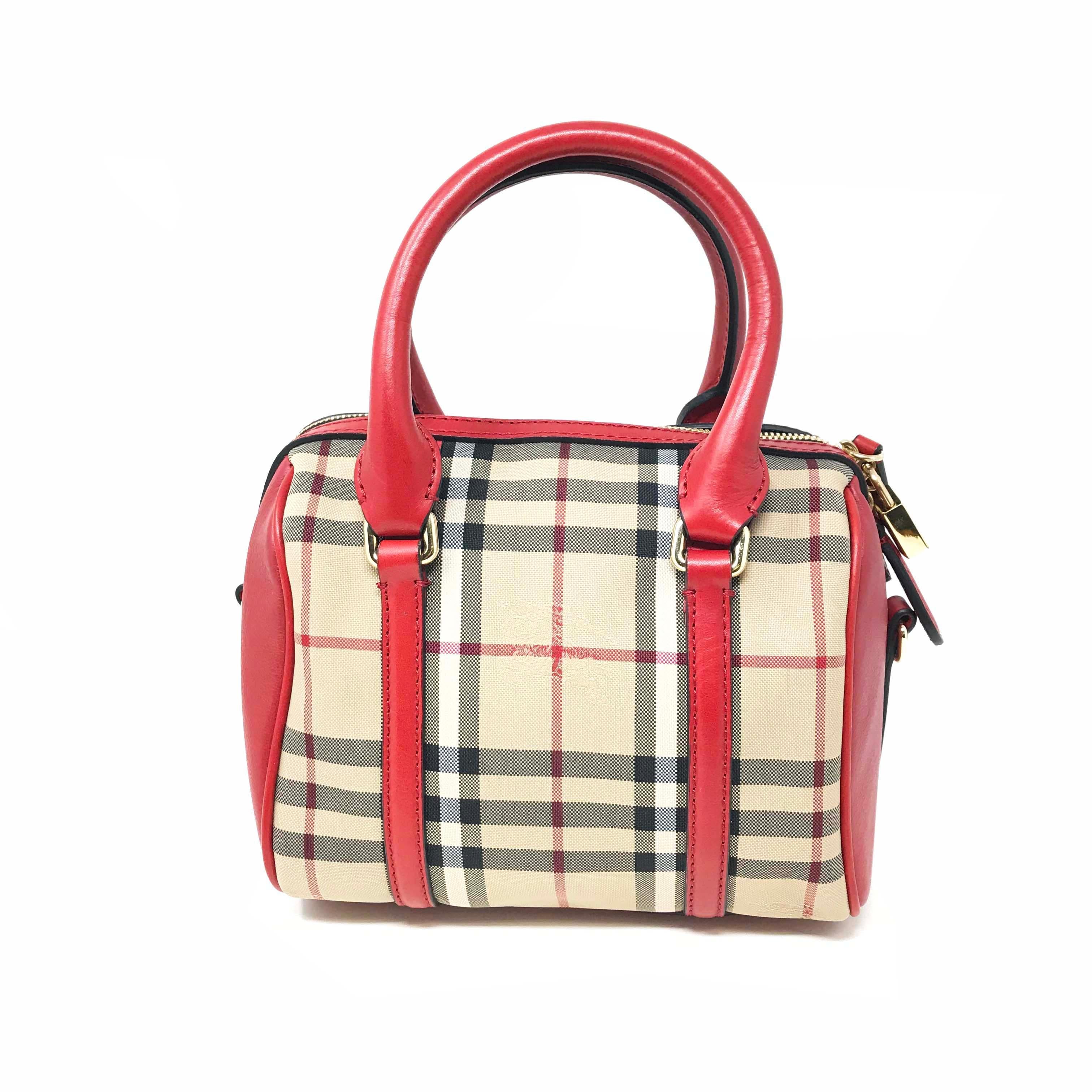 This is new with defects Burberry 3925930 Small Alchester Beige Red Ladies Handbag Purse. Signature check print bowler with Equestrian Knight detail, removable adjustable shoulder strap, made in Italy. This handbag opens with a zipper, has one