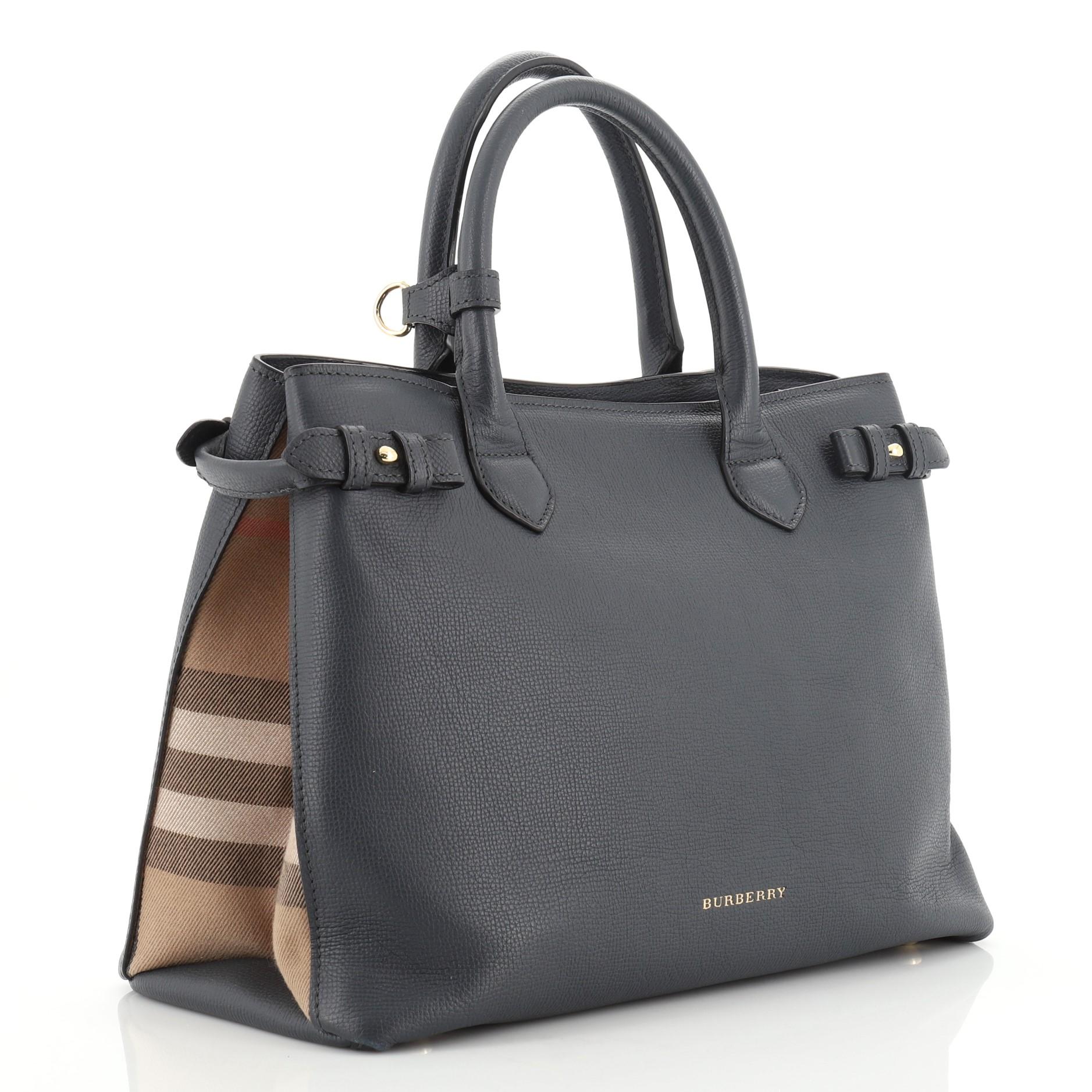 This Burberry Banner Convertible Tote Leather and House Check Canvas Medium, crafted in blue leather and house check canvas, features dual rolled handles, stamped Burberry logo, house check canvas side panels, protective base studs and gold-tone