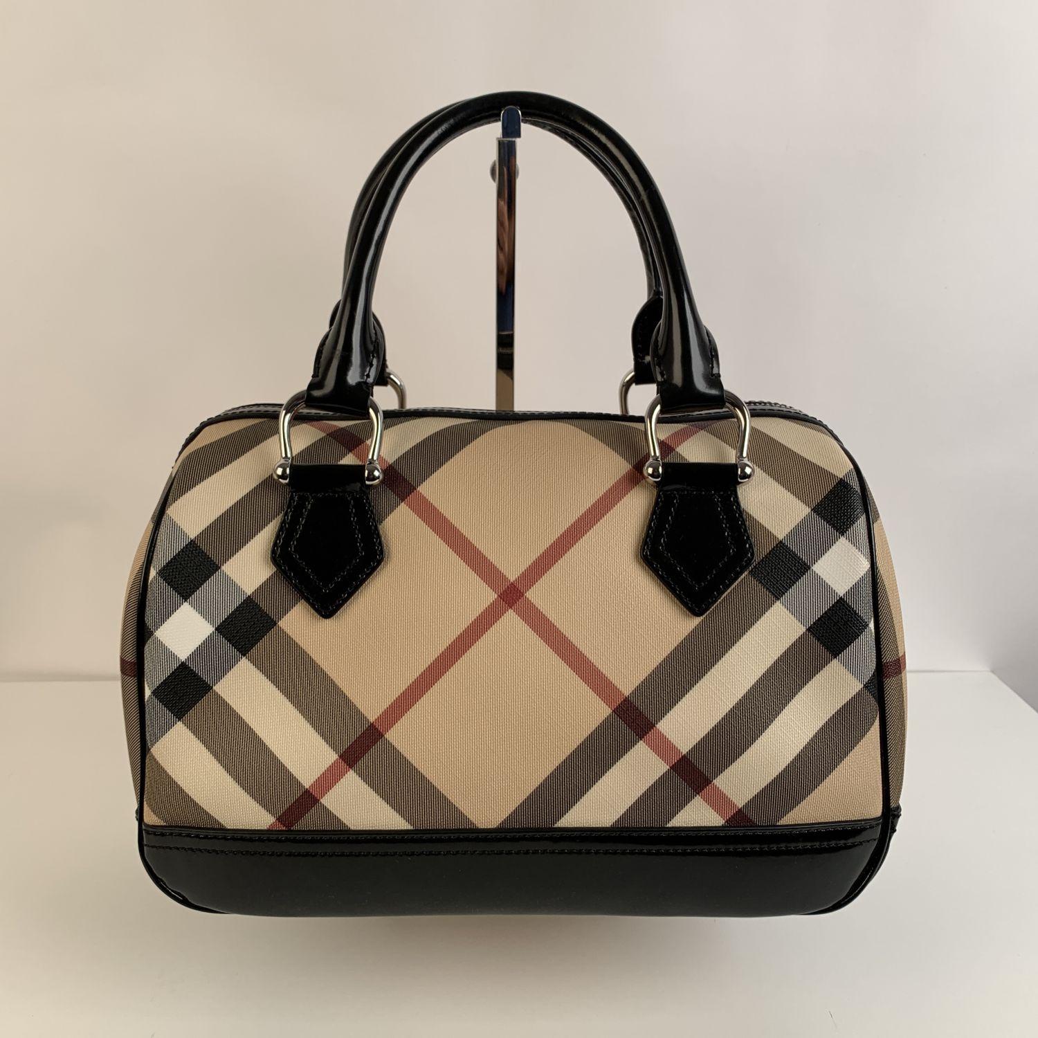 This beautiful Bag will come with a Certificate of Authenticity provided by Entrupy, leading International Fashion Authenticators. The certificate will be provided at no further cost.

- Burberry Nova Check Canvas Boston Bag
- Featuring Burberry's