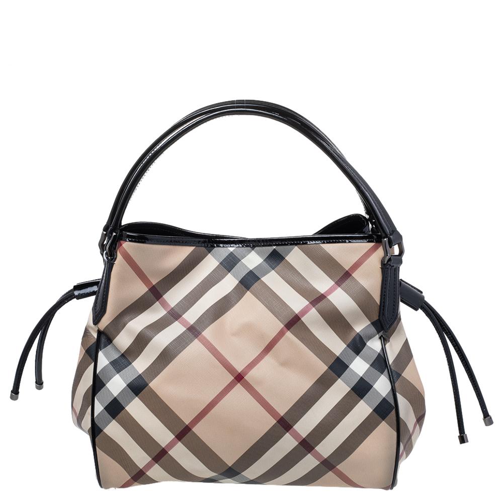 We see the iconic Nova Check grandly displayed on this Burberry Bilmore tote. It is crafted from PVC and it has patent leather trims, two handles, drawstrings on the sides, and a spacious fabric interior for your belongings.

Includes: Original
