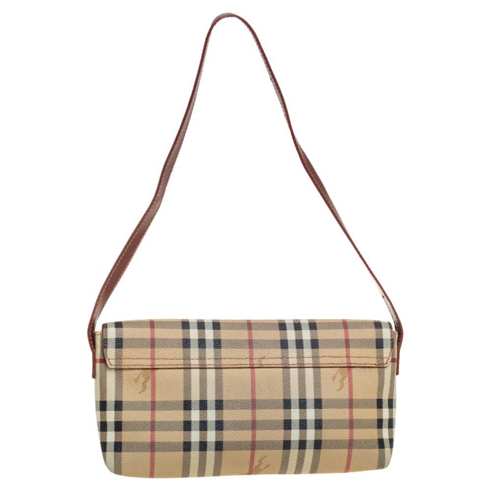 Rendered in Haymarket Check canvas and leather, this women's designer handbag from the house of Burberry is an excellent choice if you're looking for a small bag that fits whatever you need. It is complete with a leather shoulder handle making it