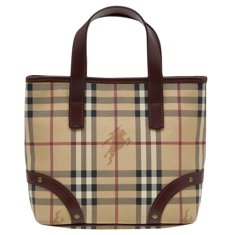 This beautifully stitched Haymarket check canvas and leather tote is by Burberry. Boasting two handles and a fine finish, this tote offers style and practical ease.
