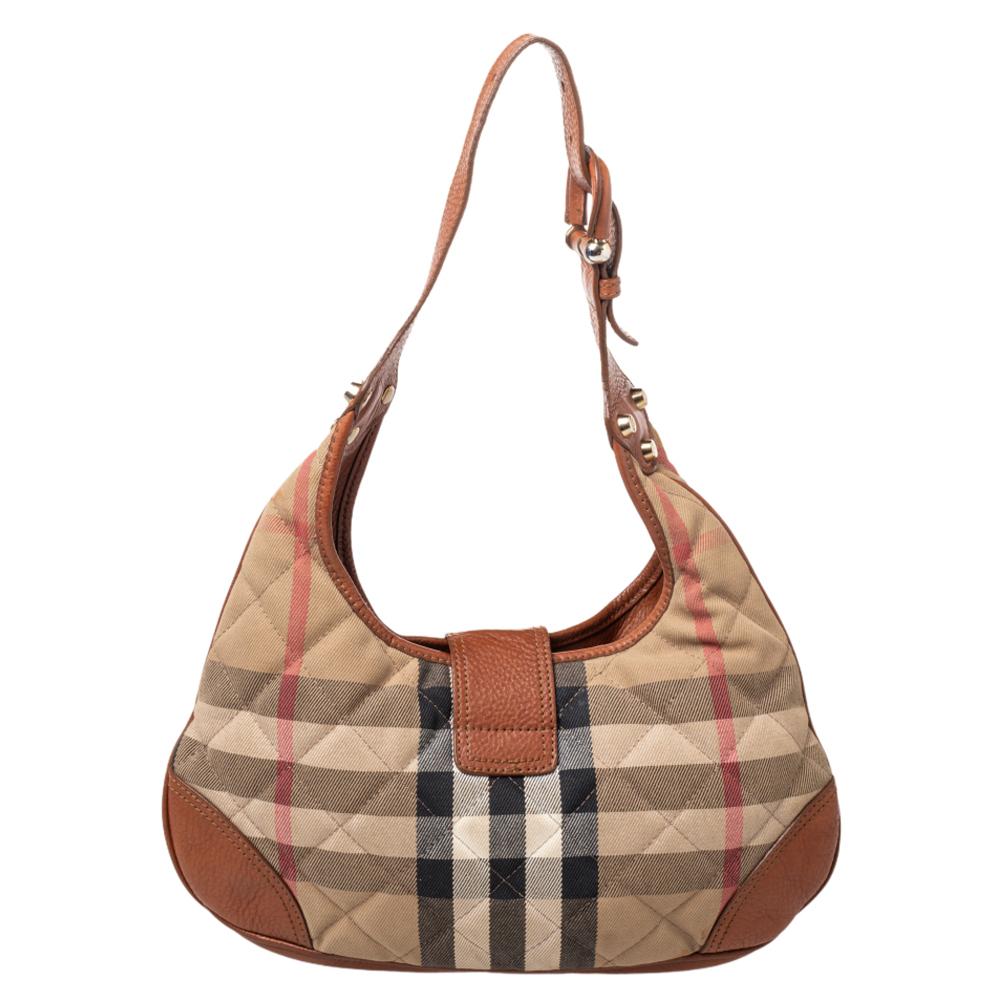 This hobo is crafted from the luxurious Haymarket check-coated canvas and leather in a gorgeous quilted style. The smooth nylon lining ensures the standard of this bag. Upgrade your look with this Burberry handbag instantly. It is complete with the