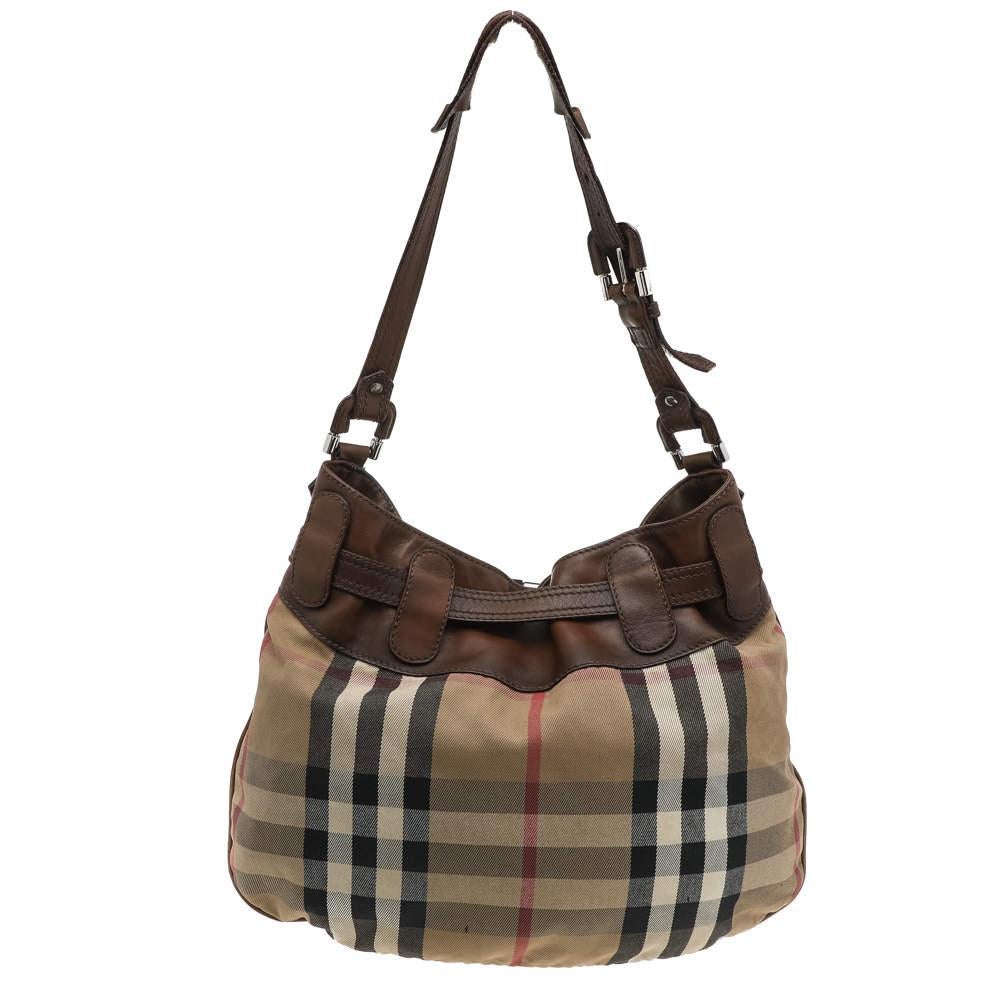 Make space in your closet for this classic beige and brown hobo from Burberry. Designed using canvas and leather, it has silver-tone hardware, a single handle, as well as a canvas interior that is sturdy enough to carry all your essentials.

